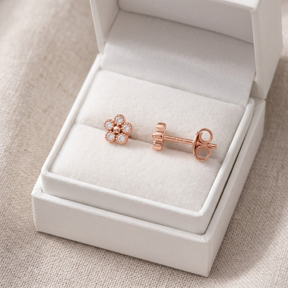 Rose Gold Vermeil Sterling Silver Ladies Tiny Flower CZ Stud Earrings in a white gift box, ready to give