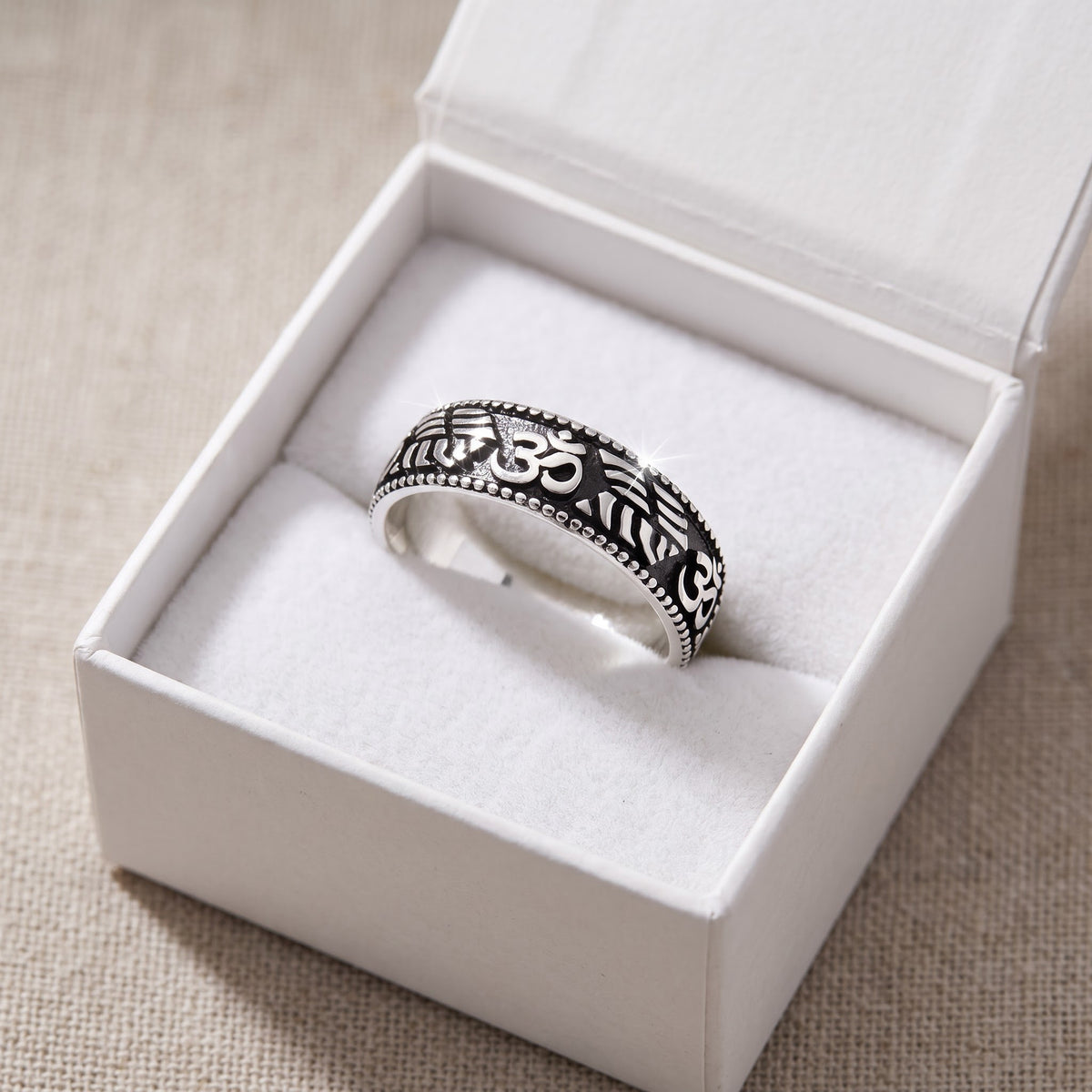 Sterling Silver Bali Carved Om Ring in a white gift box, ready to give