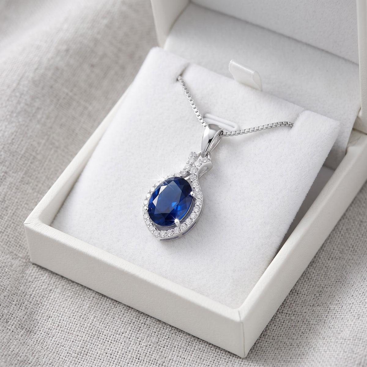 Sterling Silver Blue CZ Oval Drop Necklace in a white gift box, ready to give