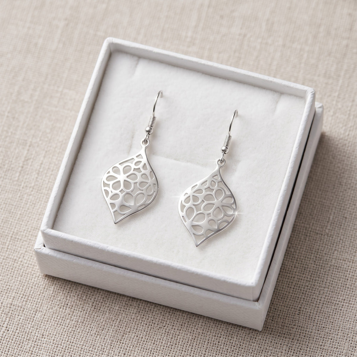 Sterling Silver Hipster Twisted Daisy Drop Flower Earrings in a white gift box, ready to give