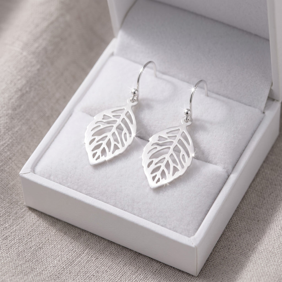 Sterling Silver Brushed Autumn Leaf Drop Earrings in a white gift box, ready to give