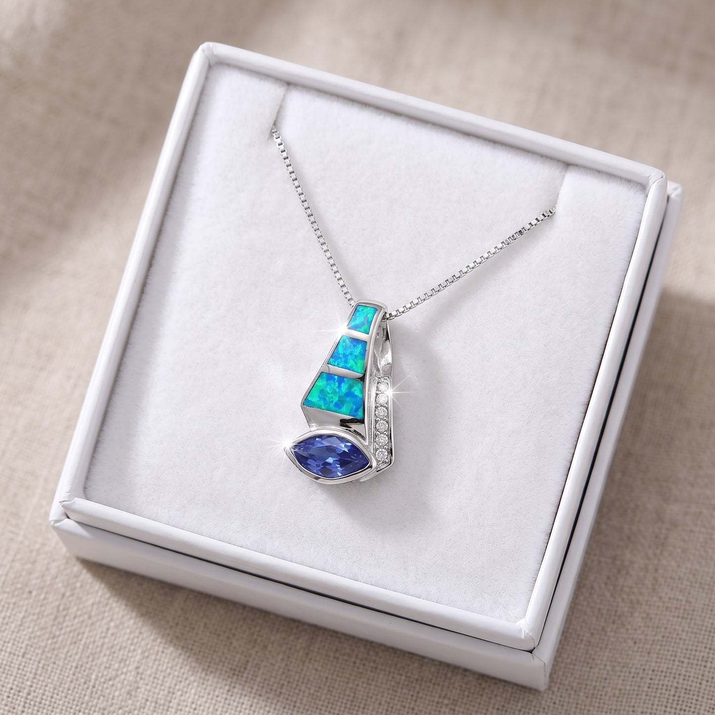 Sterling Silver Created Blue Opal CZ Drop Necklace in a white gift box, ready to give