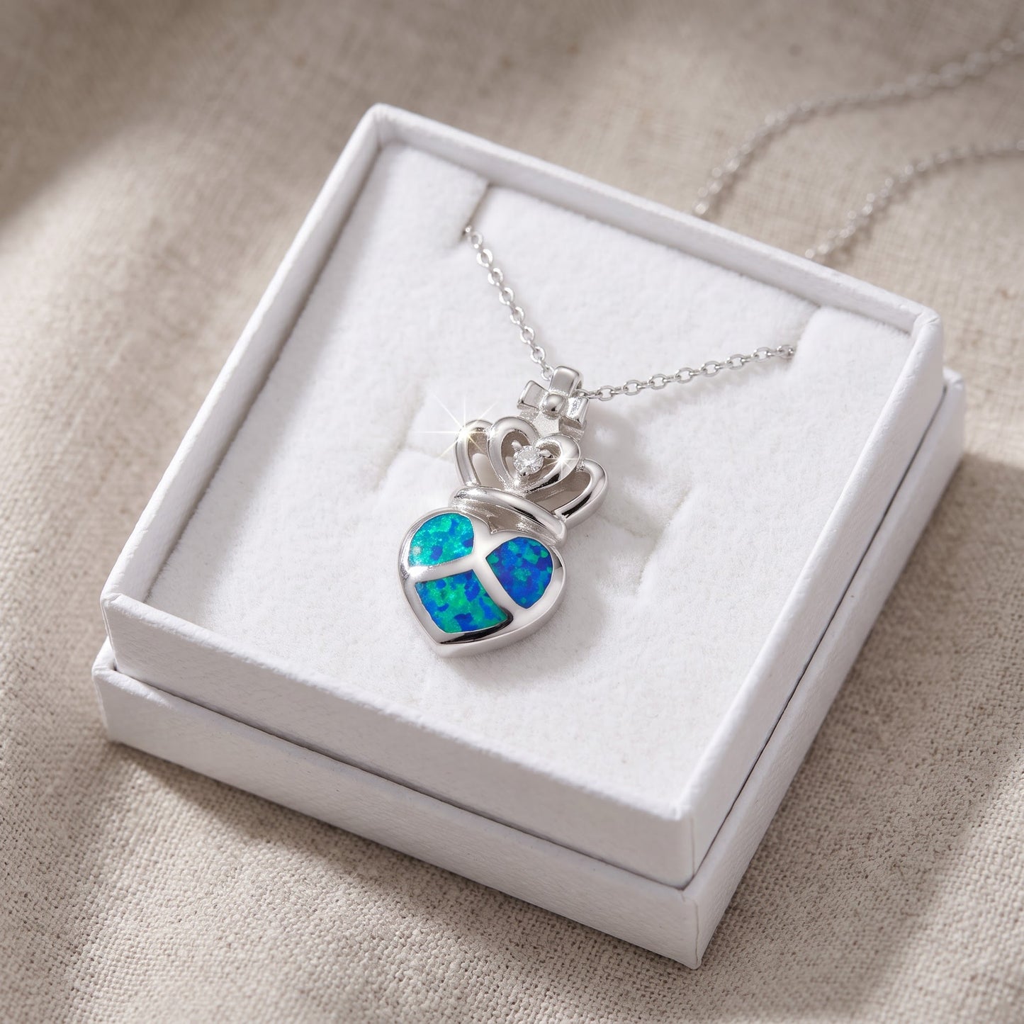 Sterling Silver CZ Created Blue Opal Crowned Heart necklace 18" in a white gift box, ready to give