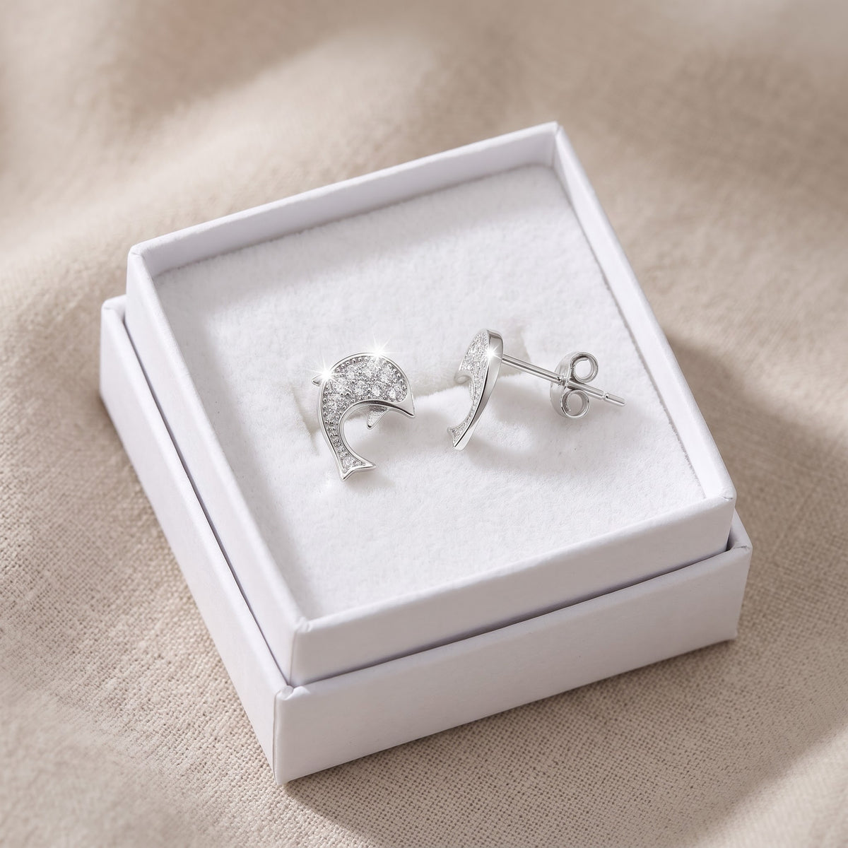 Sterling Silver CZ Dolphin Stud Earrings in a white gift box, ready to give
