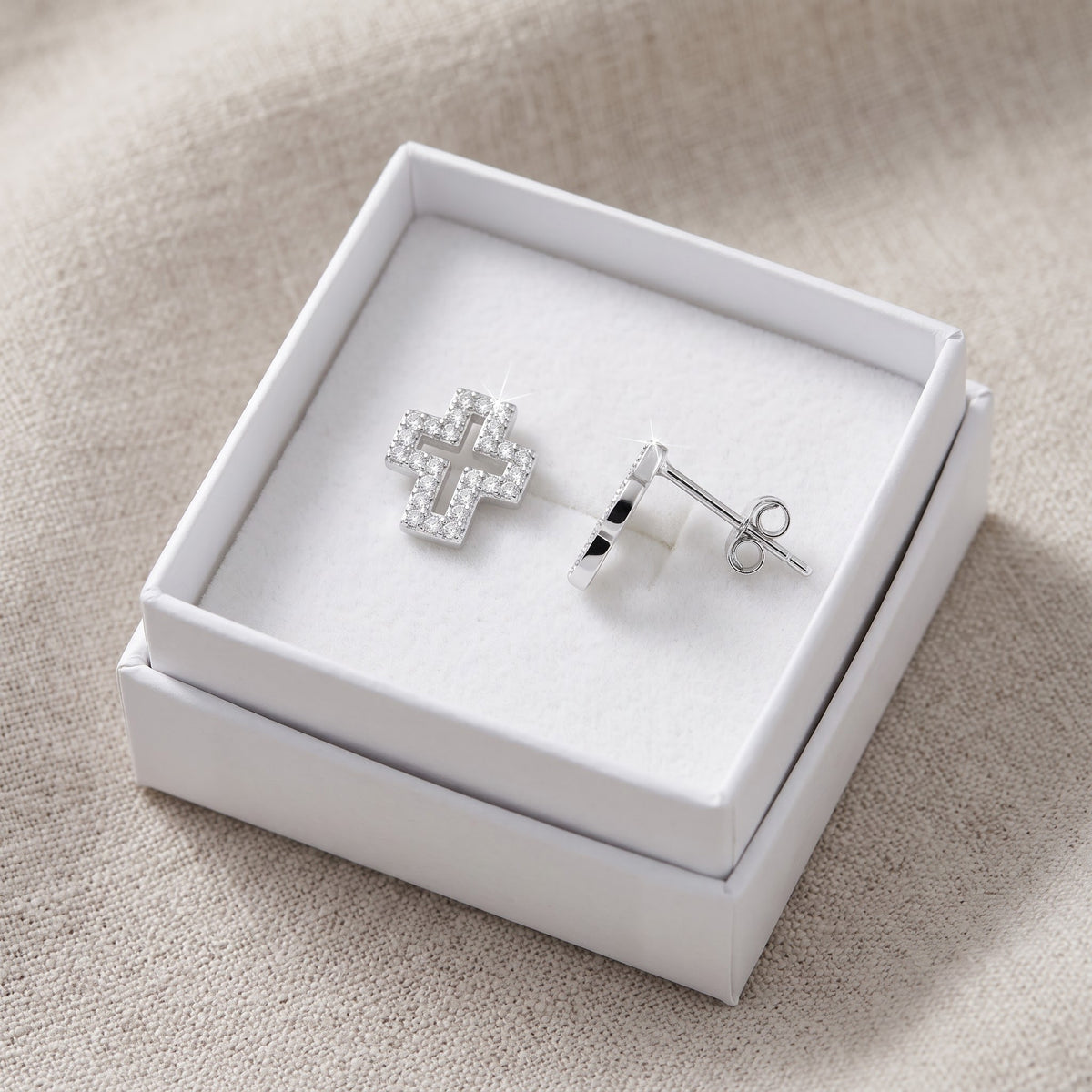 Sterling Silver CZ Hollow Cross Stud Earrings in a white gift box, ready to give