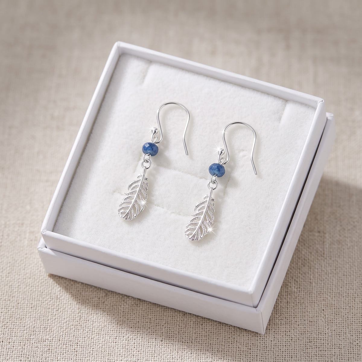 Sterling Silver Girls Blue Bead Native American Inspired Feather Drop Earrings in a white gift box, ready to give
