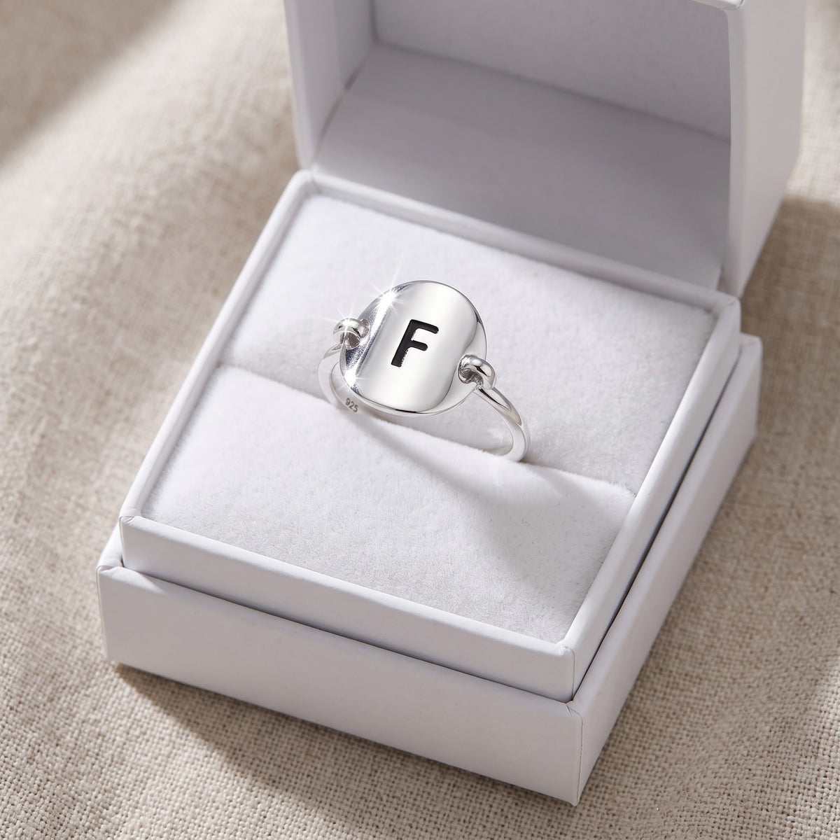Sterling Silver Oval Initial F Ring in a white gift box, ready to give