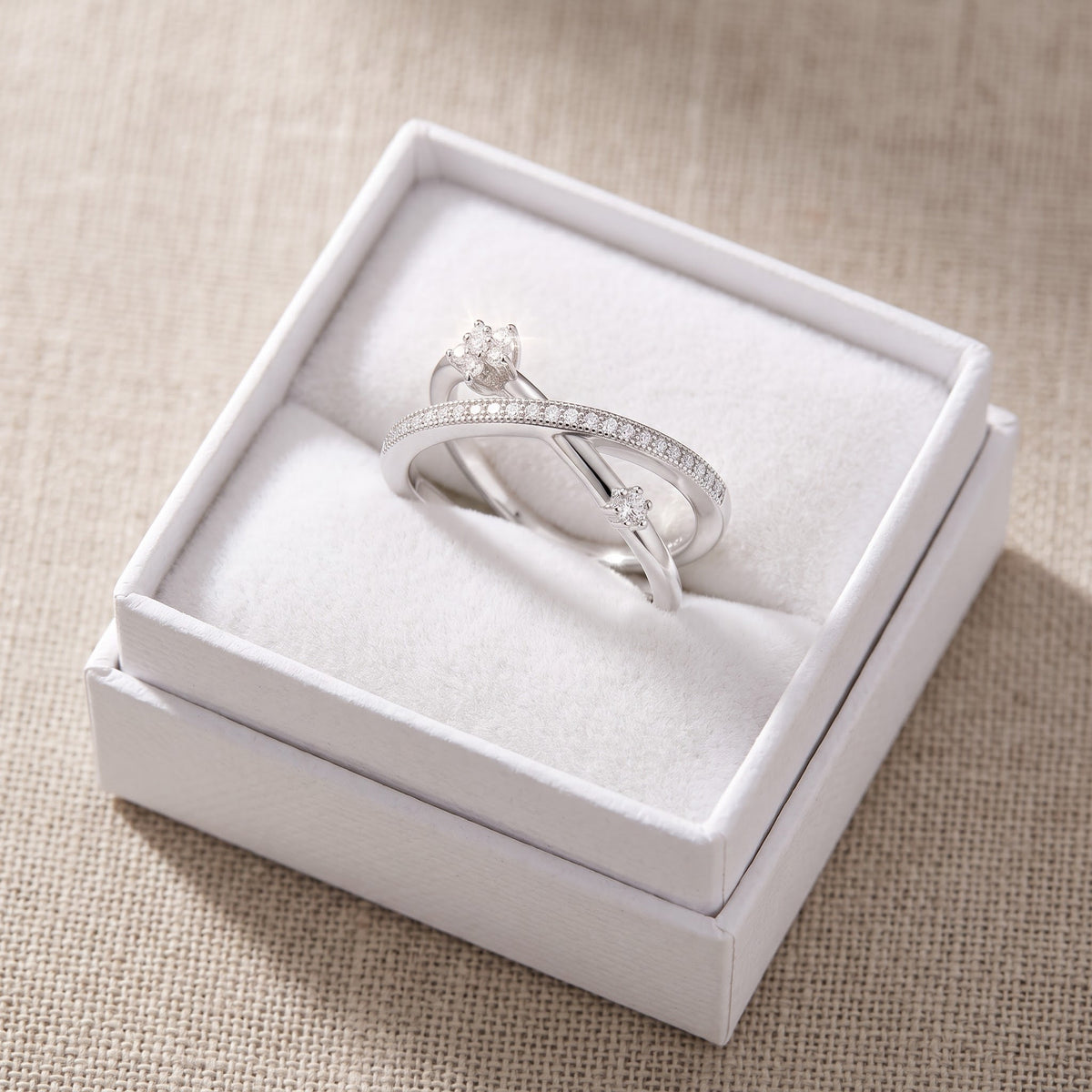 Sterling Silver Simulated Diamond Criss Cross X Flower Ring in a white gift box, ready to give