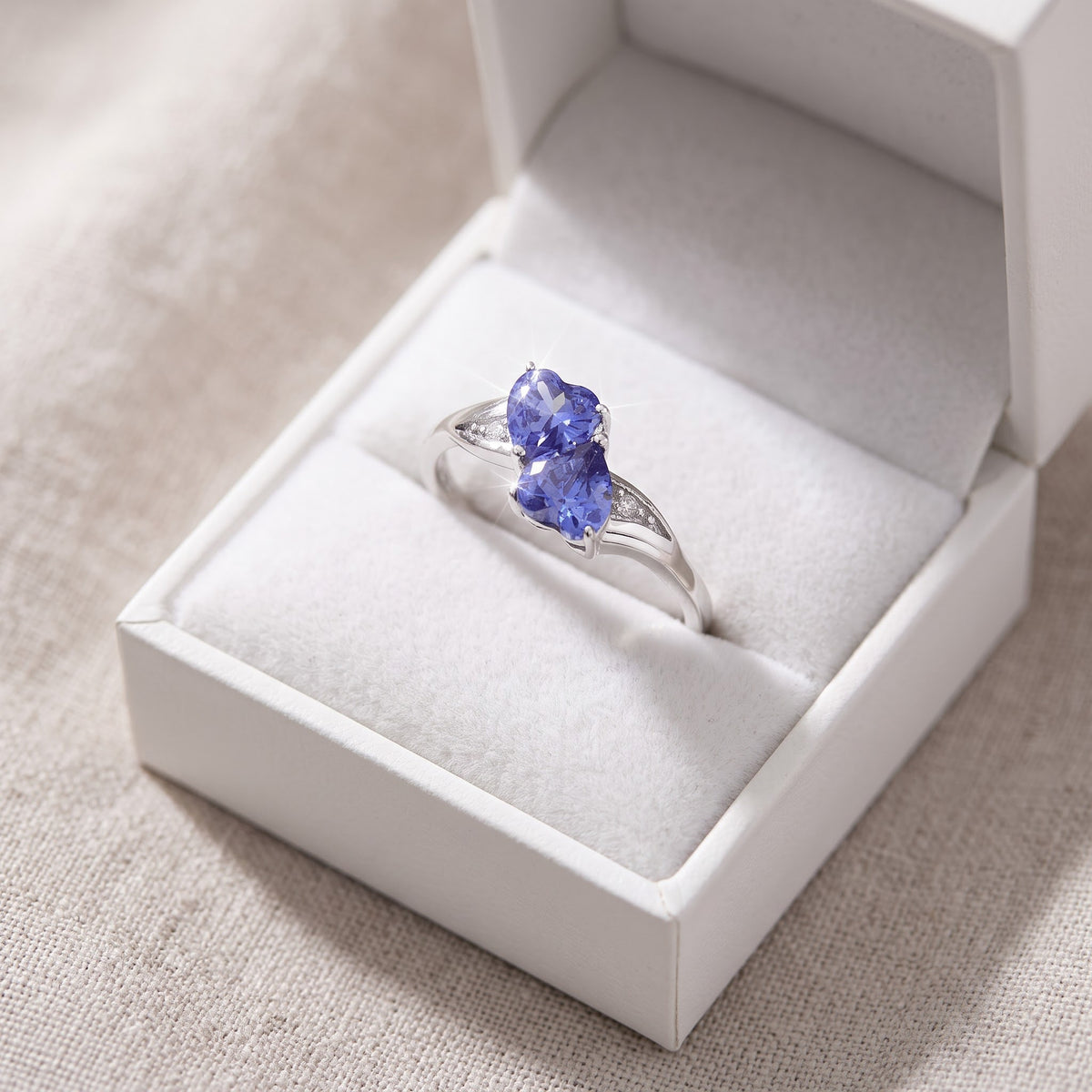 Sterling Silver Simulated Tanzanite Double Heart Ring in a white gift box, ready to give