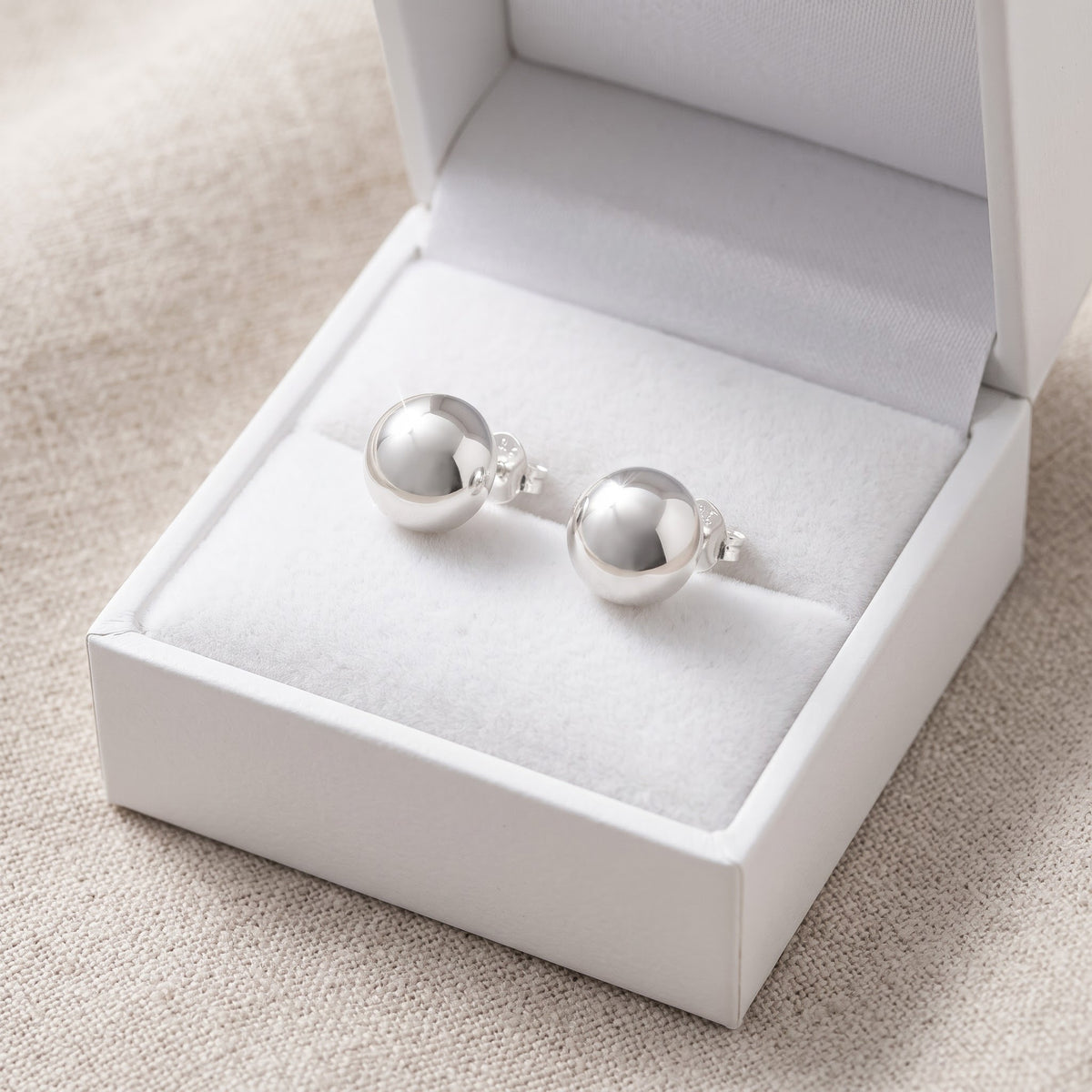 Sterling Silver Small Half Dome Stud Earrings, 8mm in a white gift box, ready to give