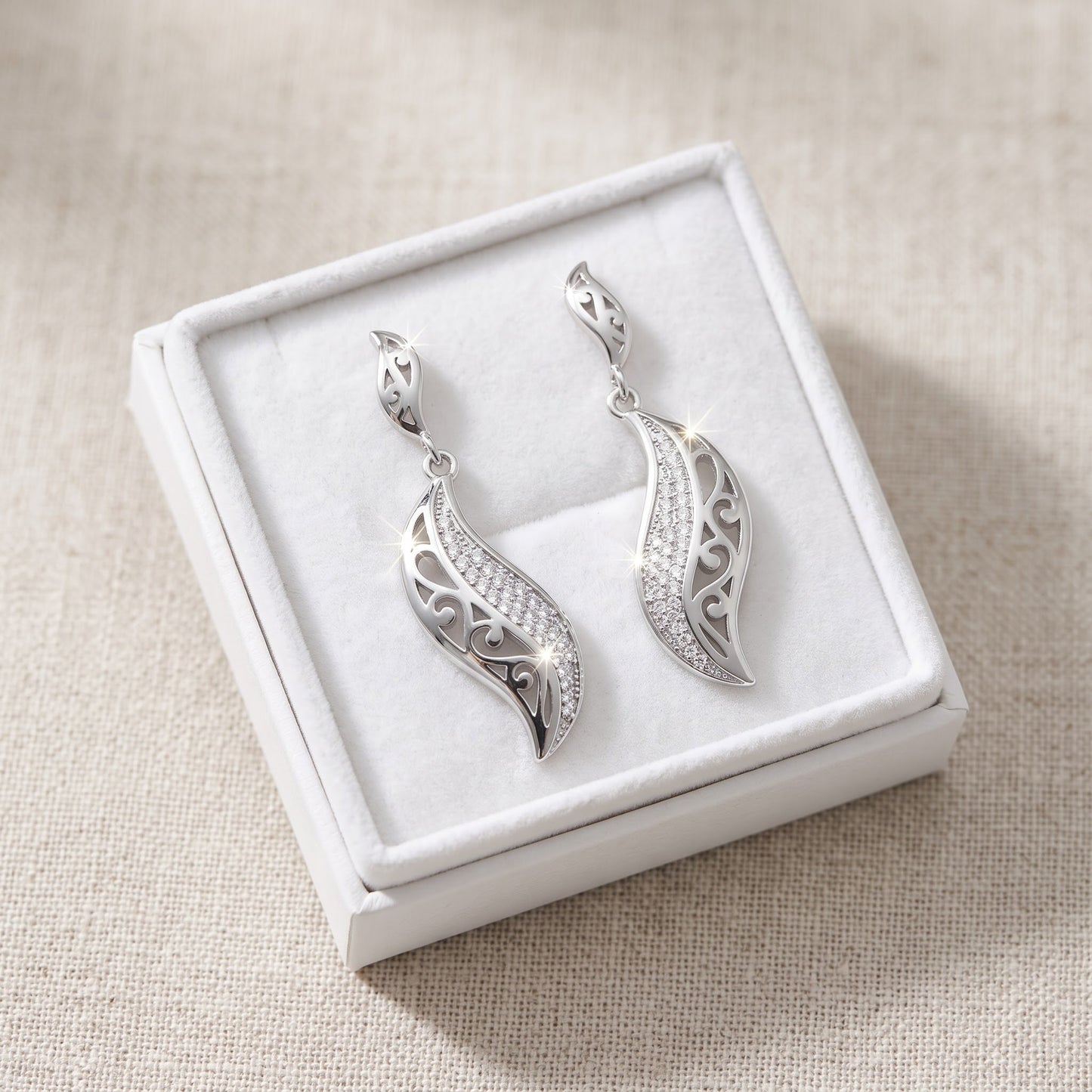 White Gold over Sterling Silver Women's CZ Intricate Leaf Dangle Earrings - 7mm in a white gift box, ready to give