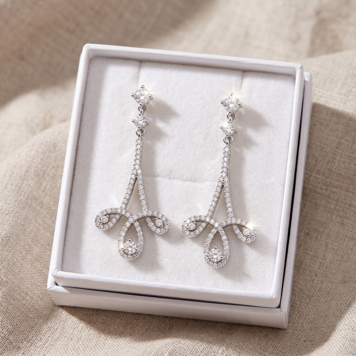White Gold over Sterling Silver Women's Designer Inspired CZ Fleur de lis Dangle Earrings in a white gift box, ready to give