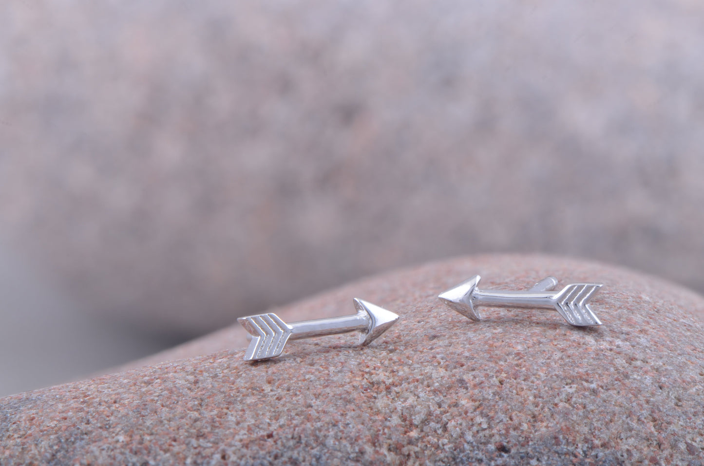 Sterling Silver Tiny Arrow Stud Earrings on stone
