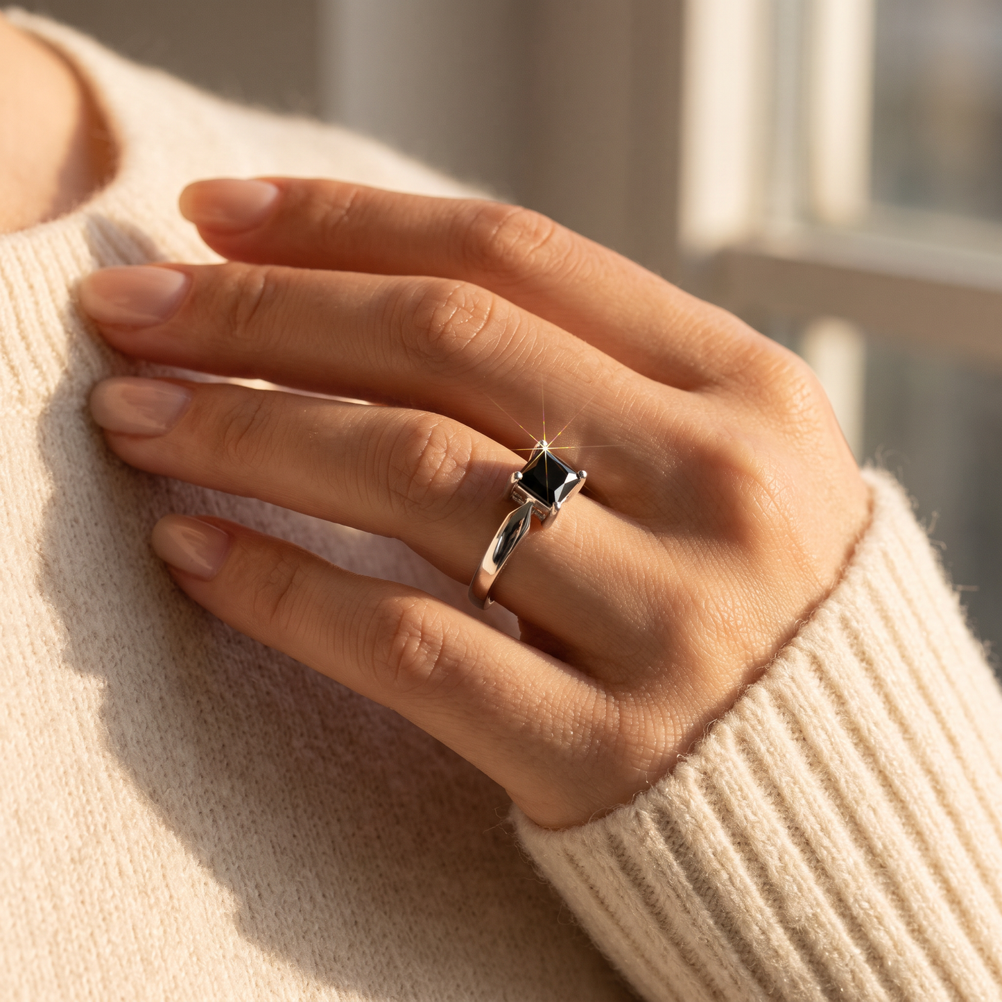 Sterling Silver Square Black CZ Ring worn on a woman's hand in warm window light