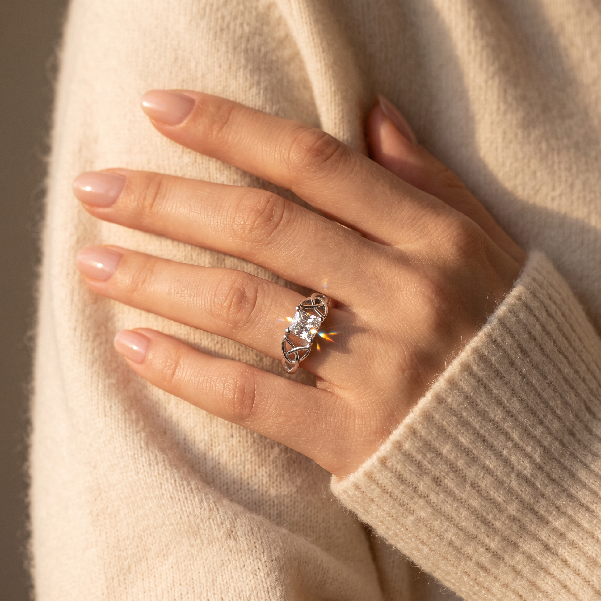 Sterling Silver Celtic Princess Cut Clear CZ Ring worn on a woman's hand in warm window light