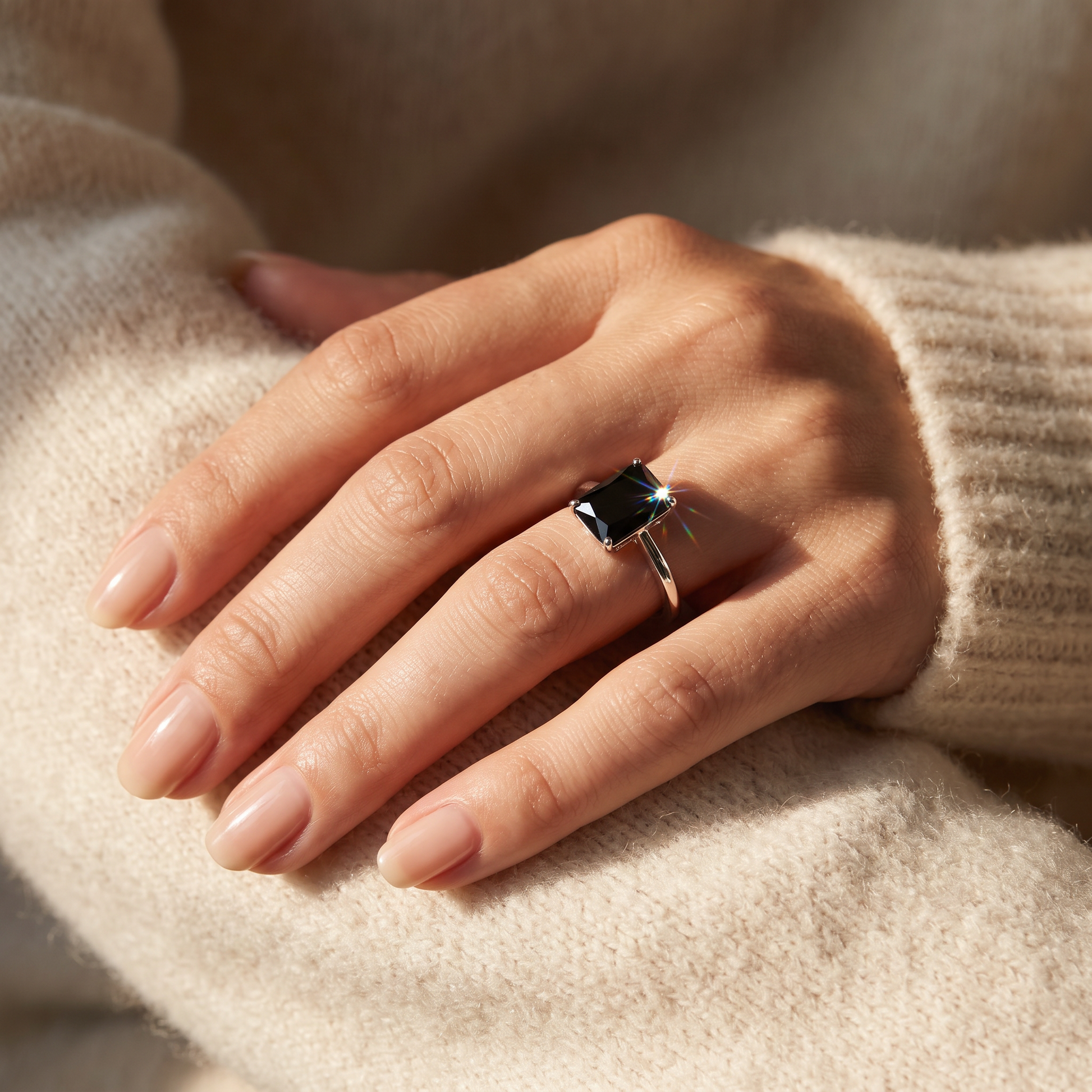 Sterling Silver Black Radiant Cut CZ Ring worn on a woman's hand in warm window light