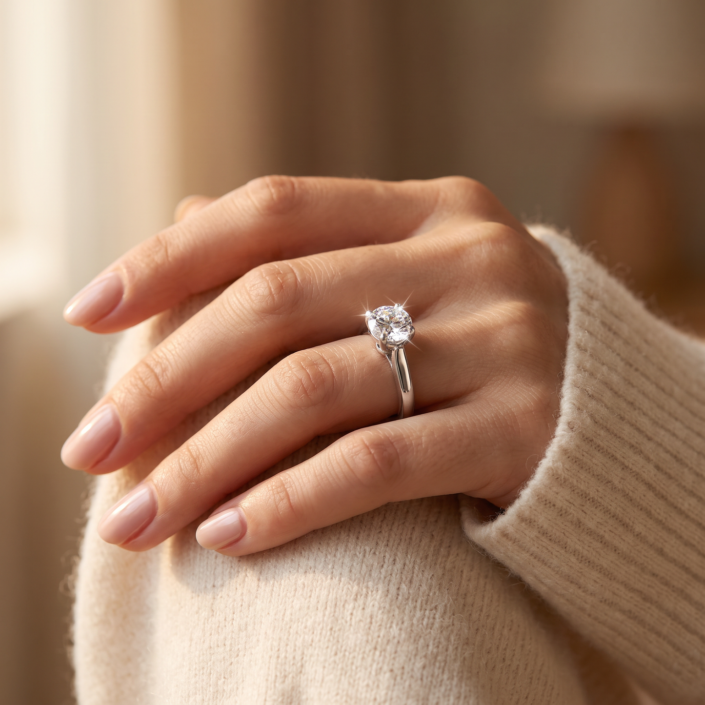Sterling Silver 6.5mm Clear CZ Cathedral Setting Ring worn on a woman's hand in warm window light