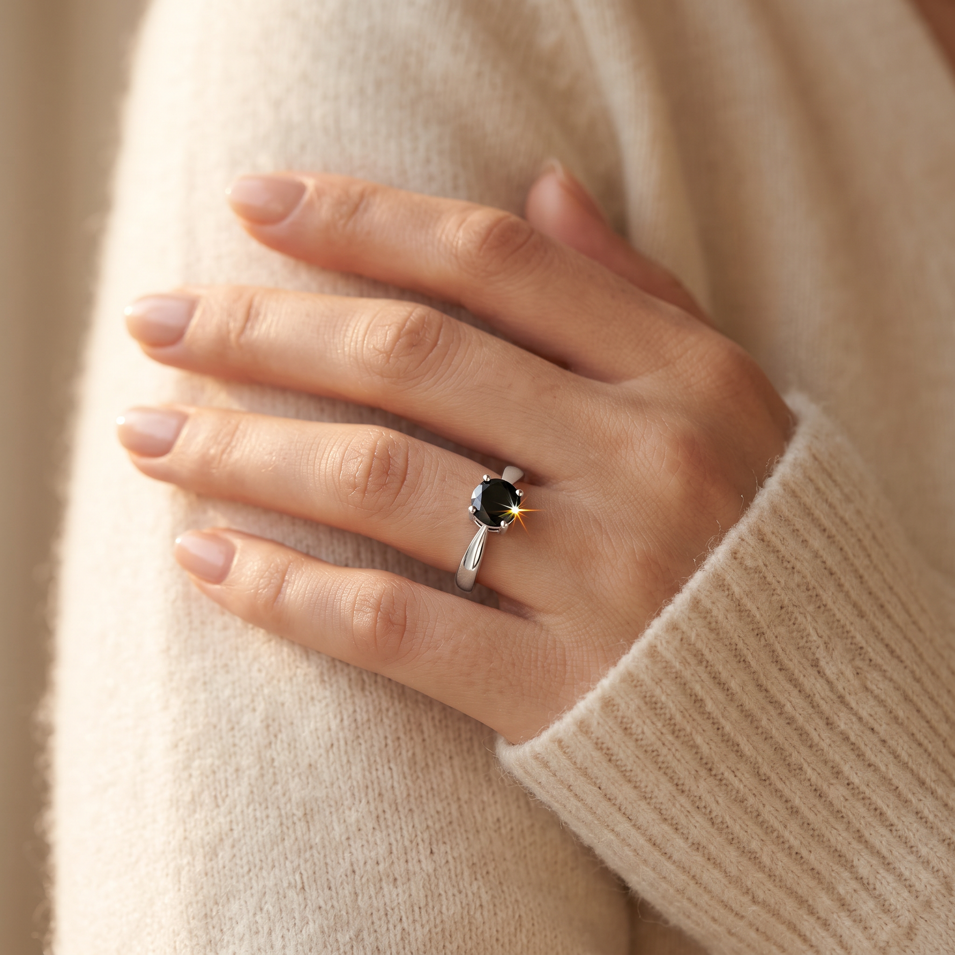 Sterling Silver 6mm Round Black CZ Ring worn on a woman's hand in warm window light