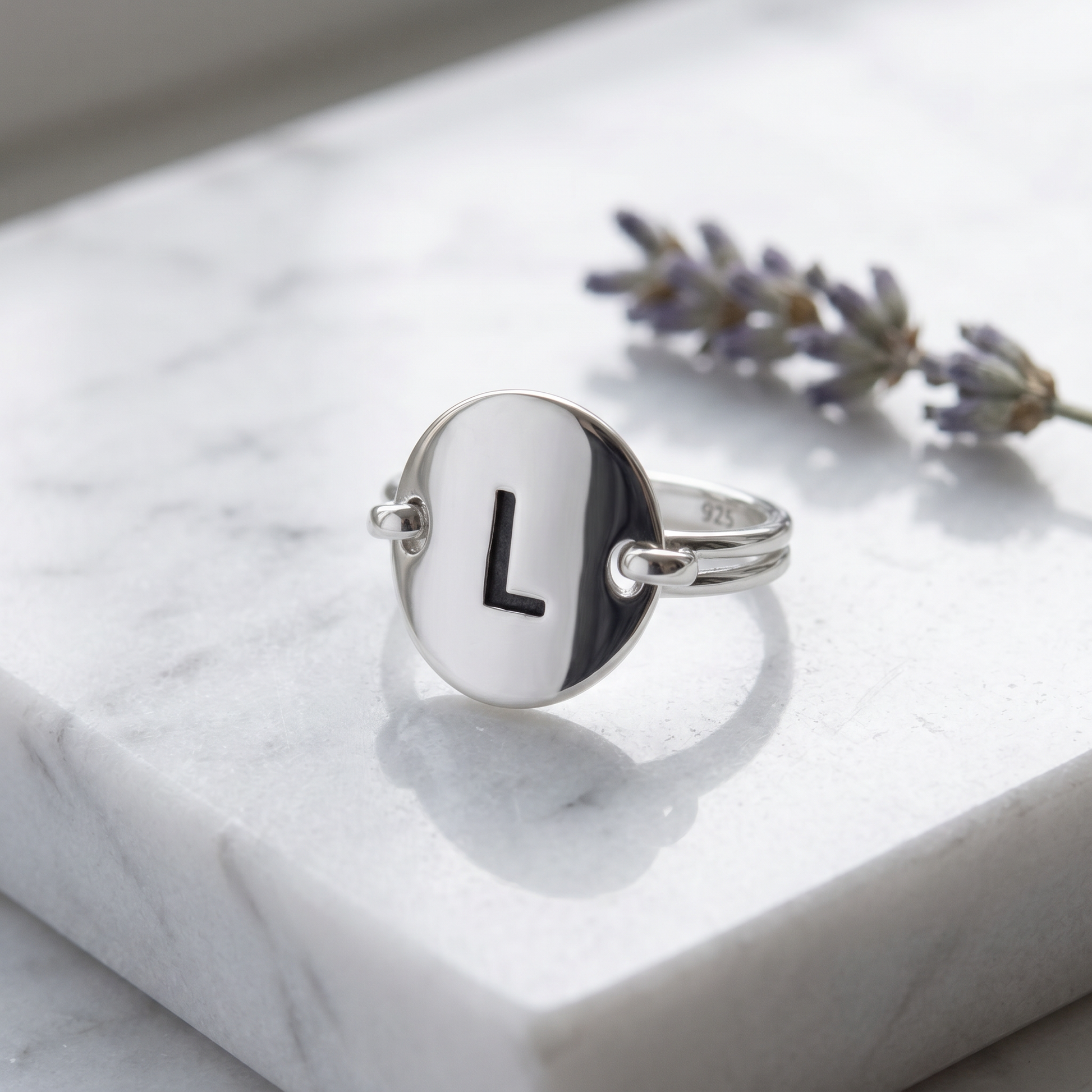 Sterling Silver Oval Initial L Ring on marble