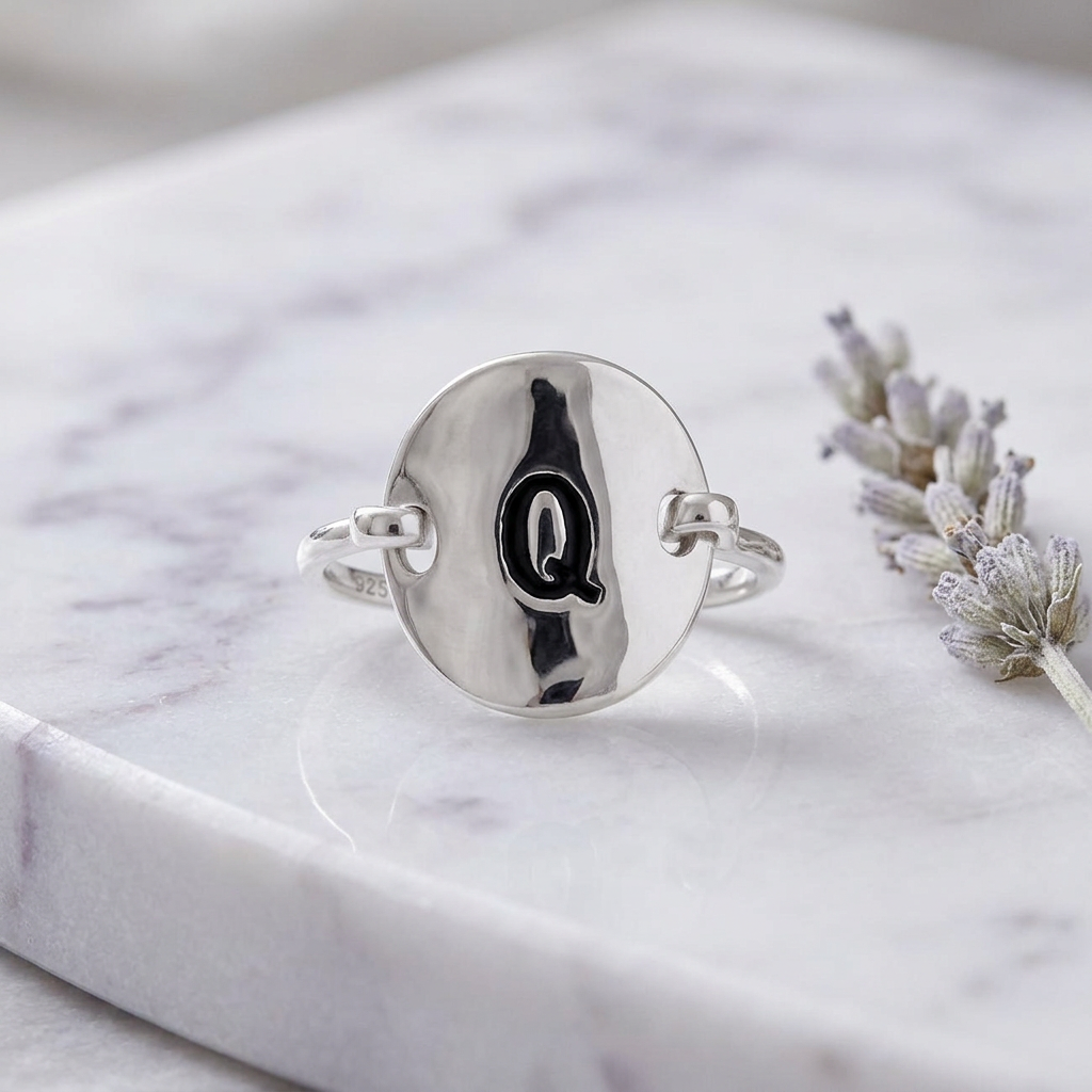 Sterling Silver Oval Initial Q Ring on marble