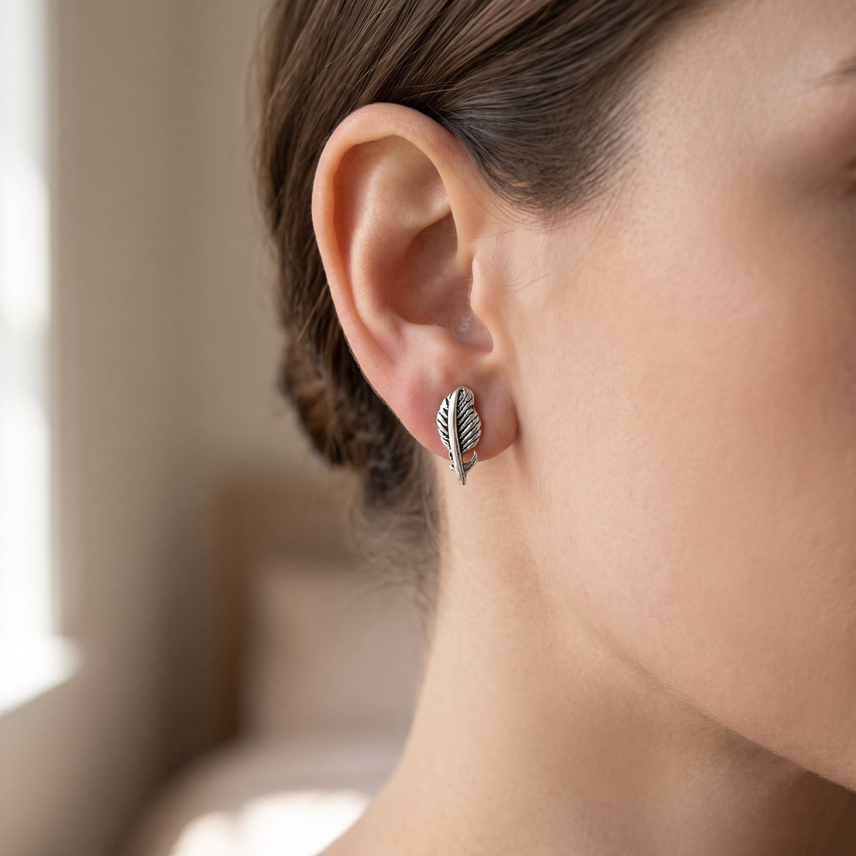 Sterling Silver Feather Stud Earrings, 8mm worn, lifestyle photo