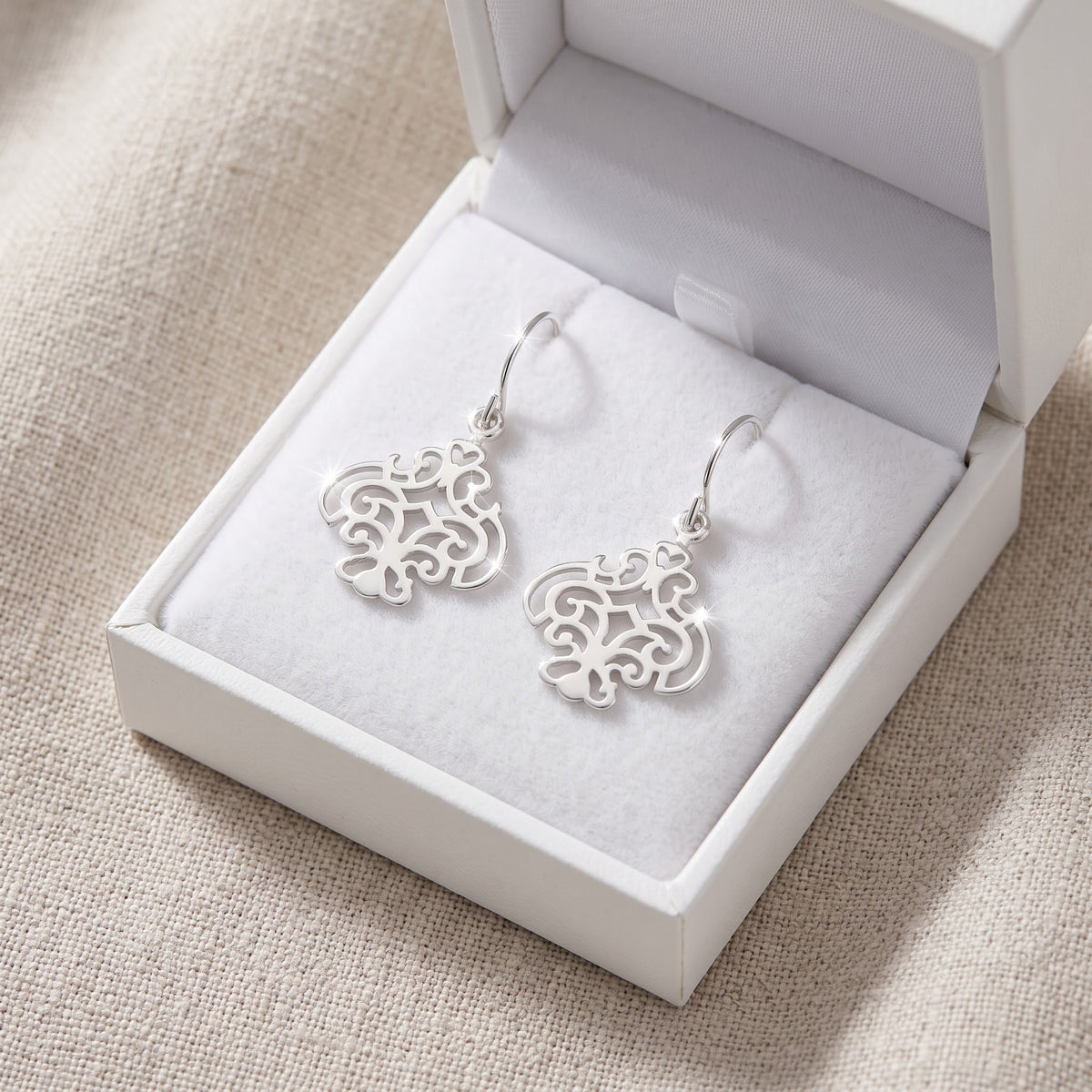 Sterling Silver Filigree Fleur De Lis Fish Hook Earrings in a white gift box, ready to give