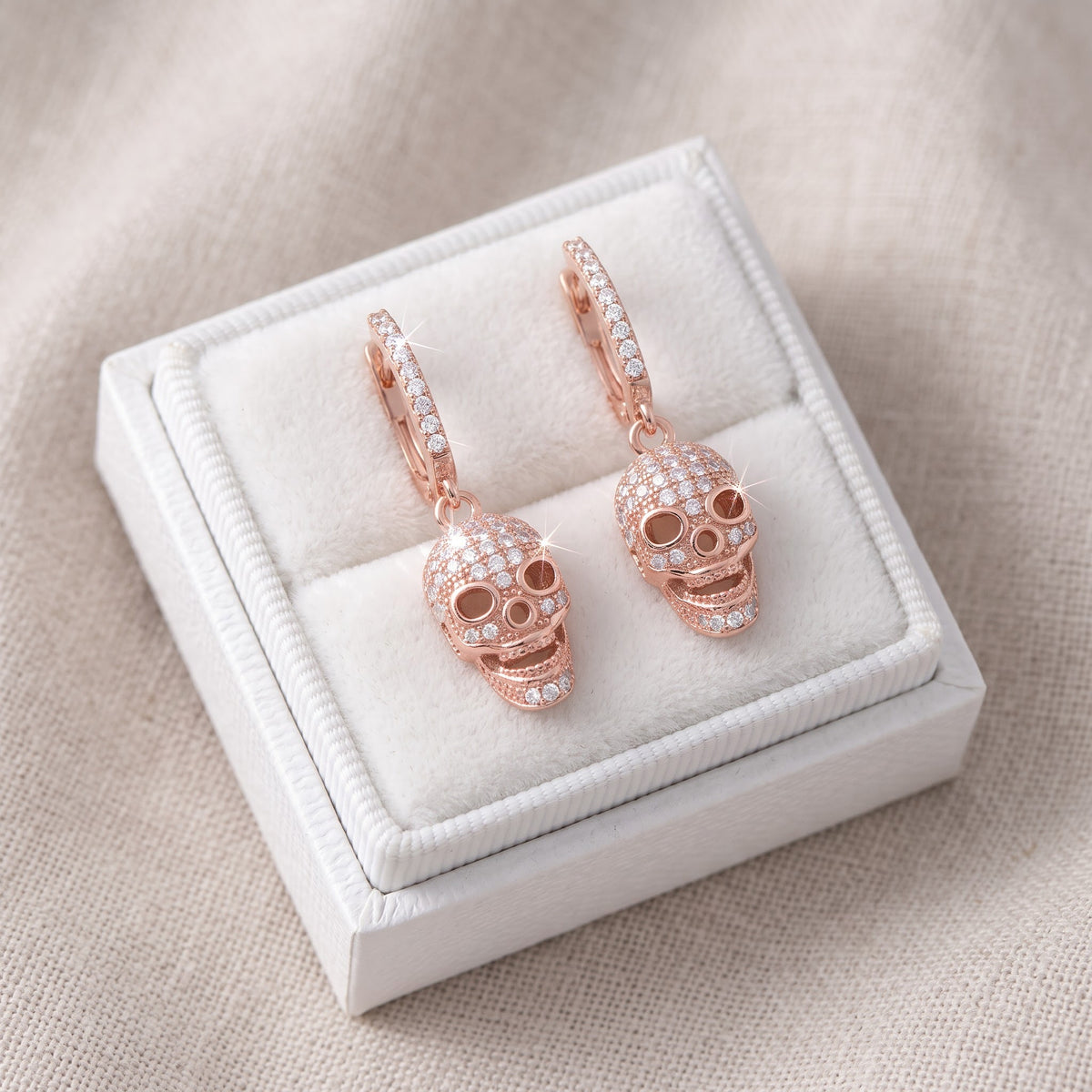 Rose Gold CZ Women's French Clip Dangle Sugar Skull Earrings, 23mm in a white gift box, ready to give