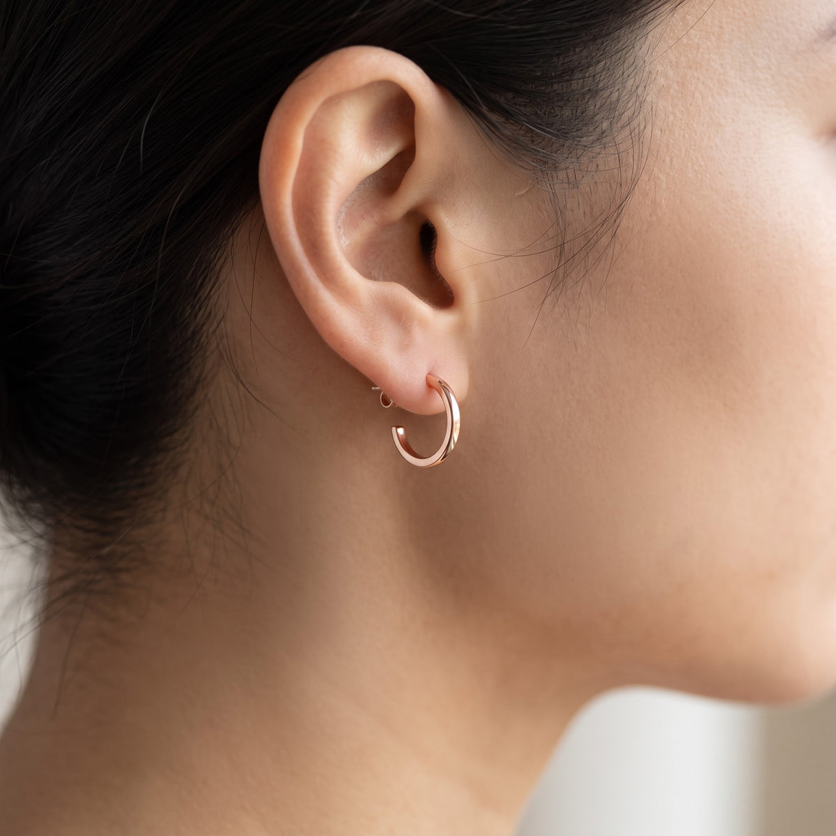 Rose Gold Small Huggie Earrings, 11mm worn, lifestyle photo