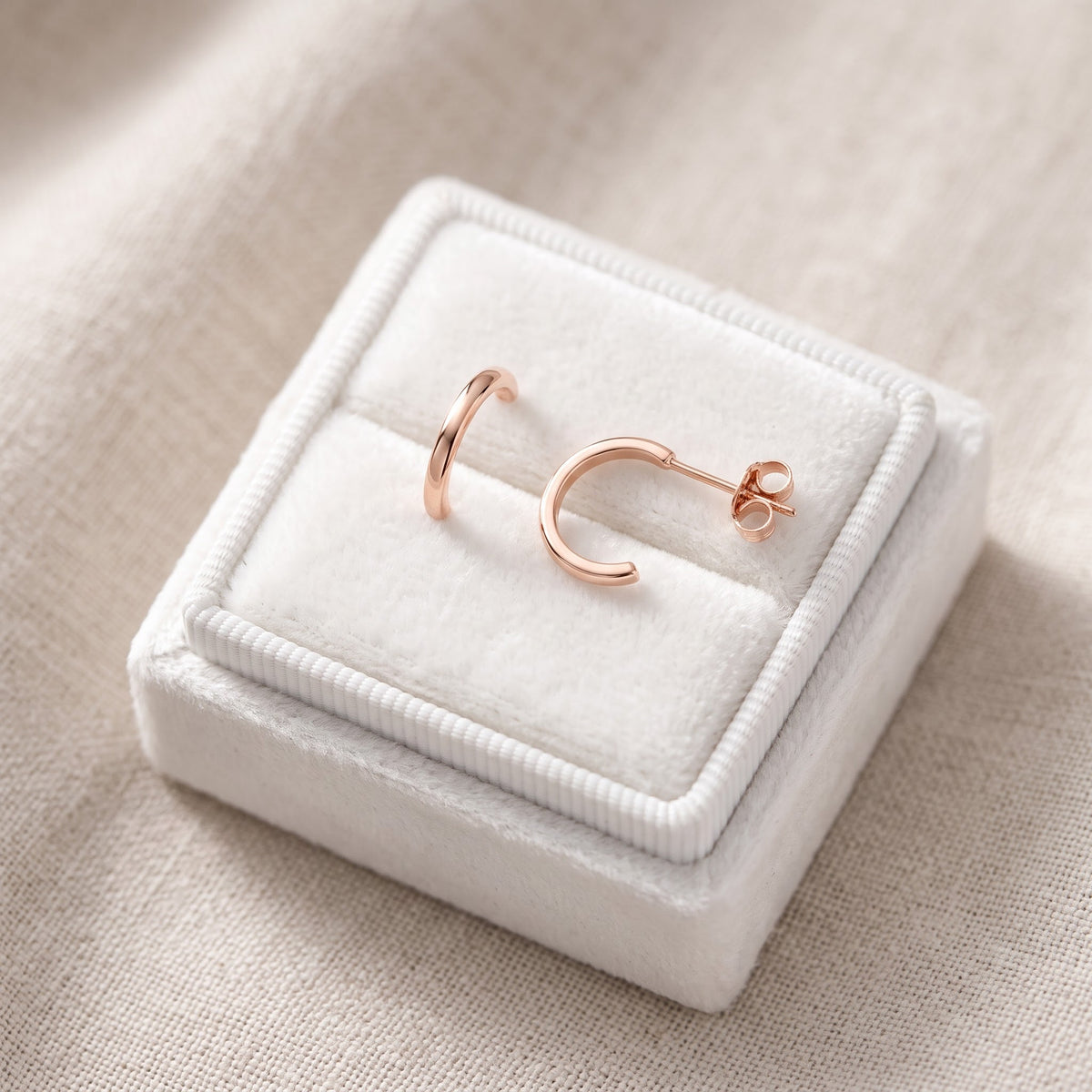 Rose Gold Small Huggie Earrings, 11mm in a white gift box, ready to give