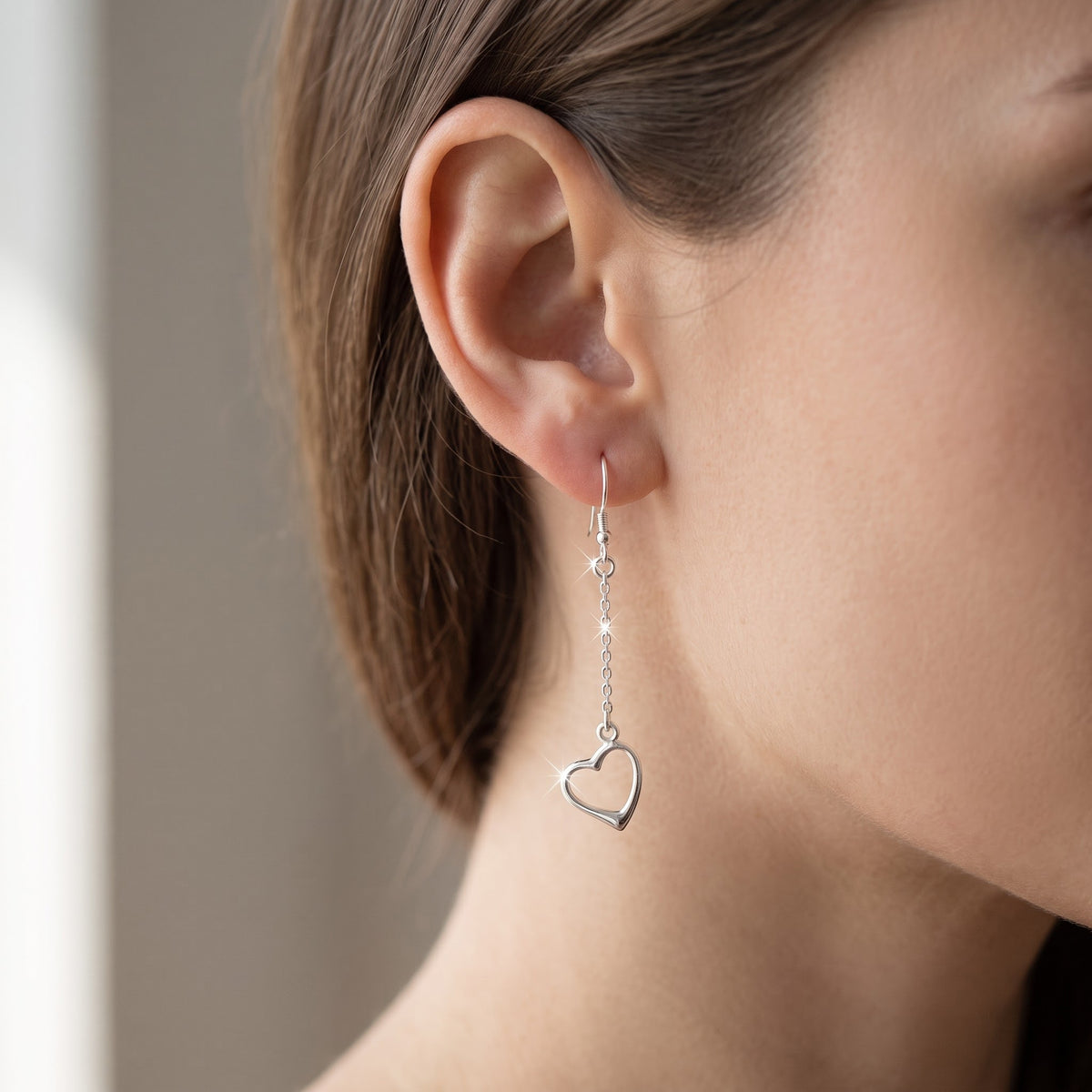 Sterling Silver Dangling Heart Fishhook Drop Earrings for Women worn, lifestyle photo