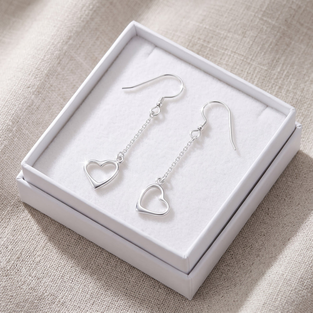 Sterling Silver Dangling Heart Fishhook Drop Earrings for Women in a white gift box, ready to give