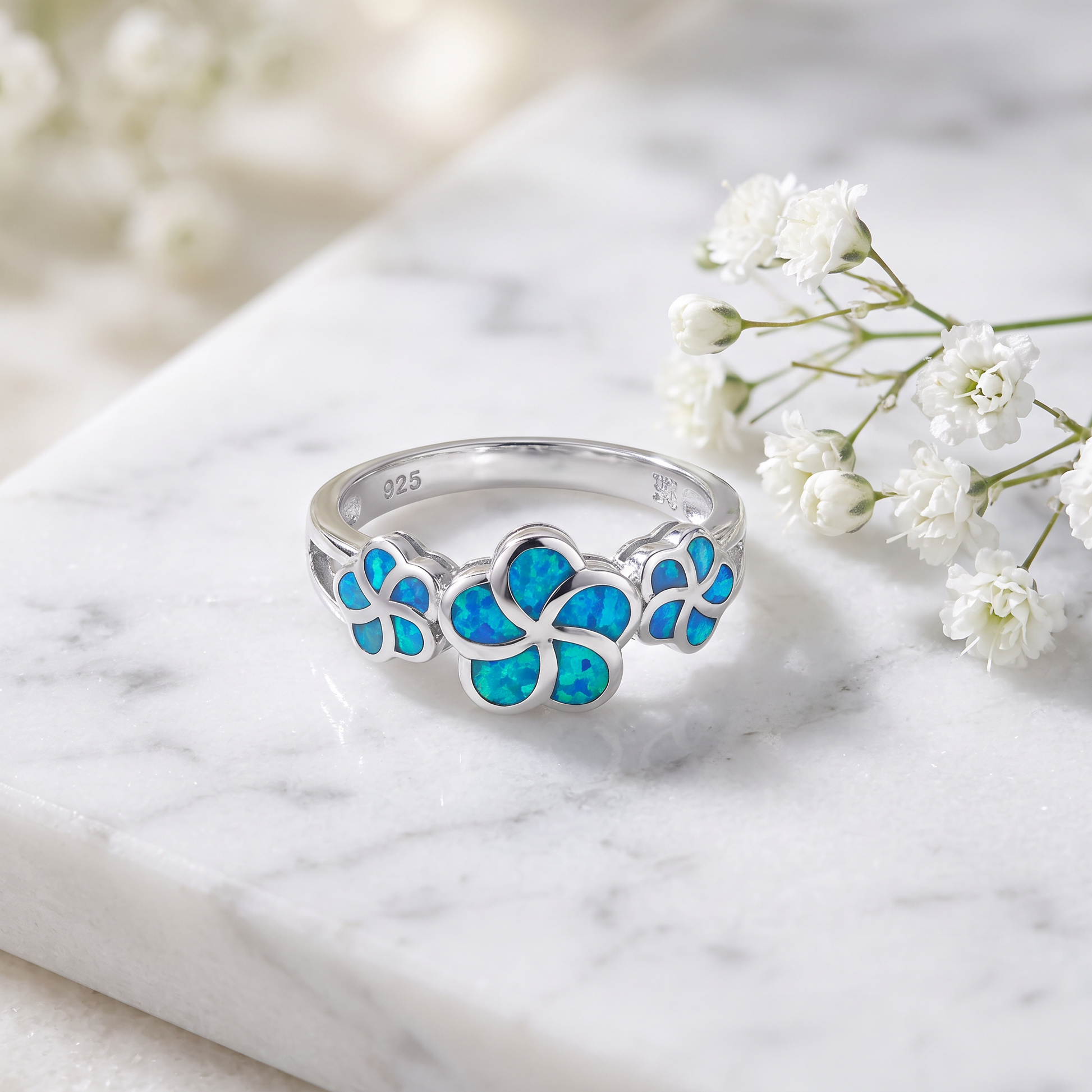 Sterling Silver Lab Opal Plumeria Ring on marble