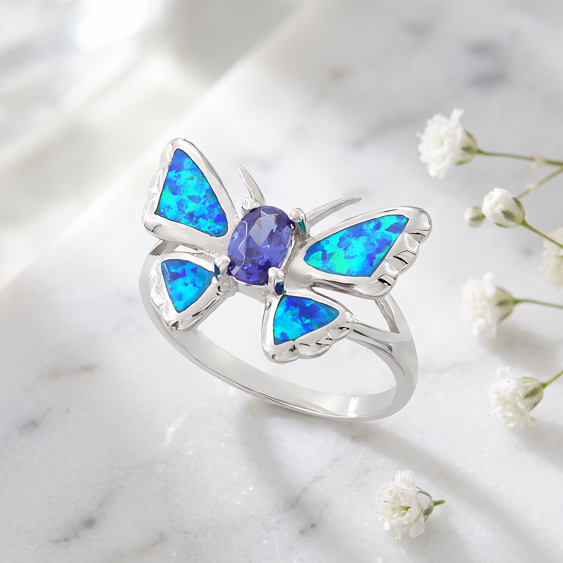 Sterling Silver Lab Opal Butterfly Tanzanite CZ Ring on marble