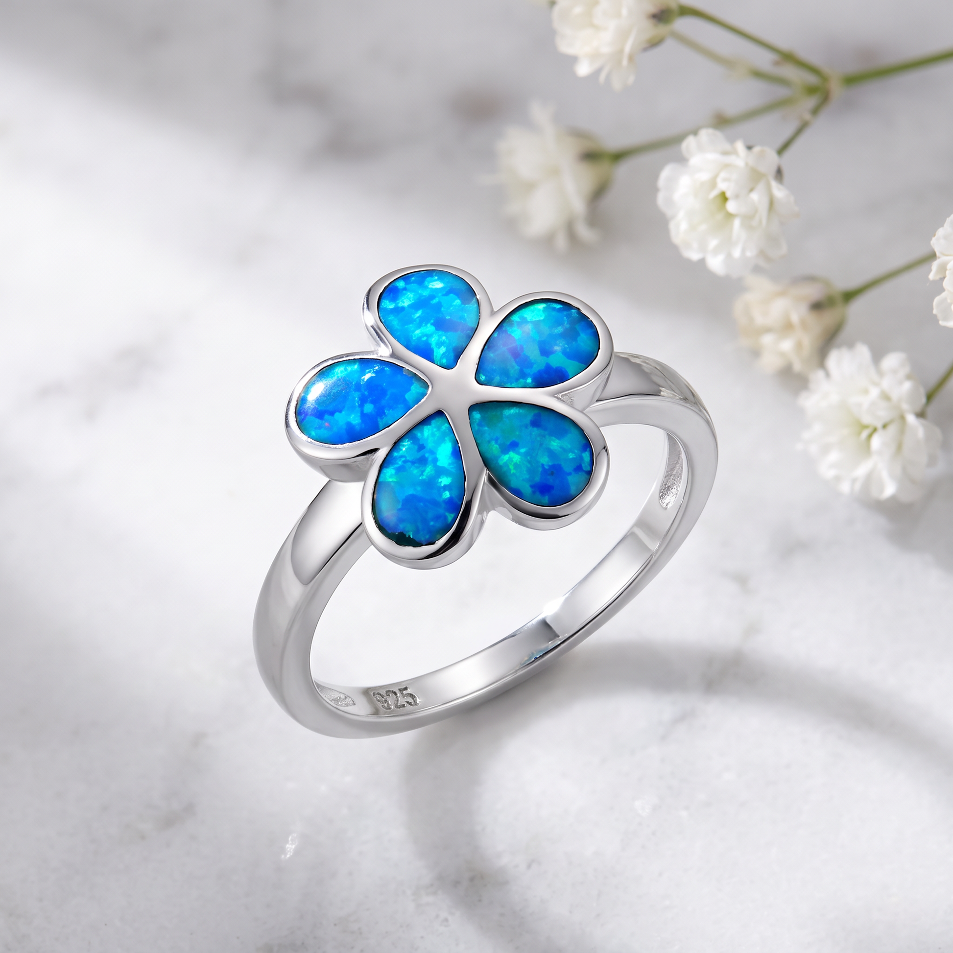 Sterling Silver Plumeria Lab Opal Ring on marble
