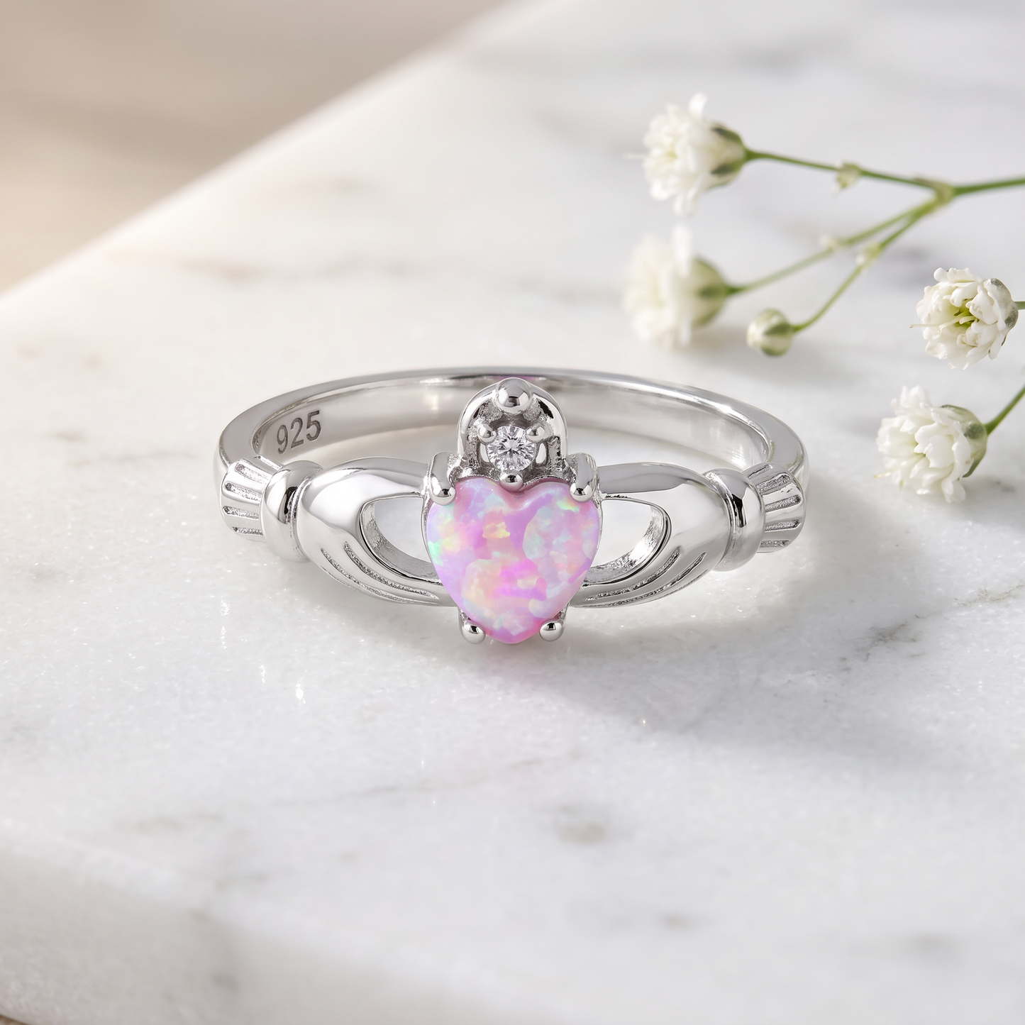 Sterling Silver Claddagh Pink Lab Opal CZ Ring on marble