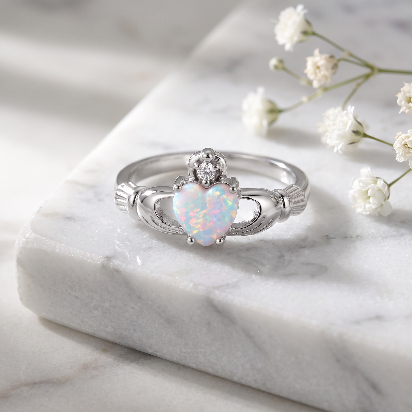 Sterling Silver Claddagh Lab Opal CZ Ring on marble