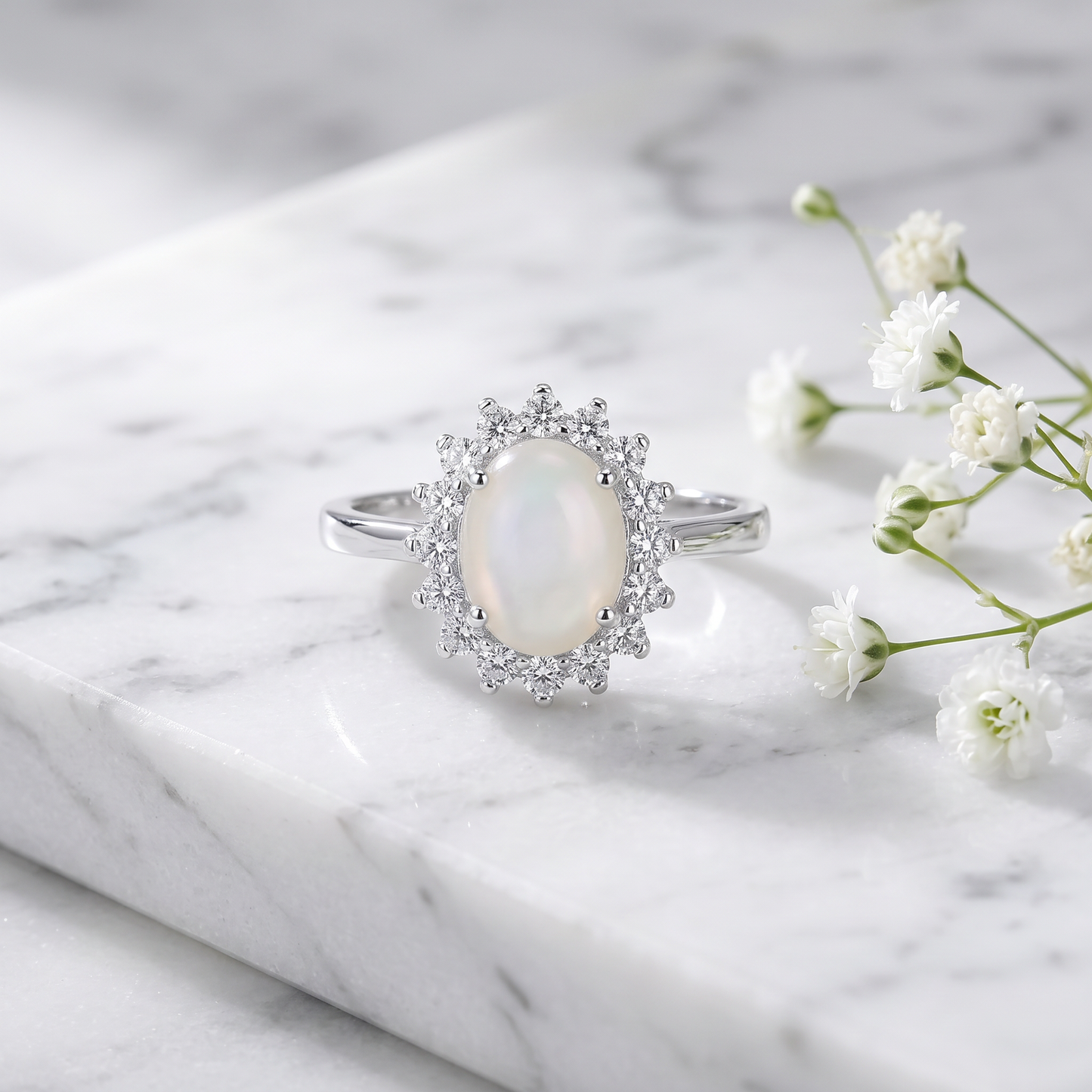 Sterling Silver Oval Mother of Pearl Opal CZ Ring on marble