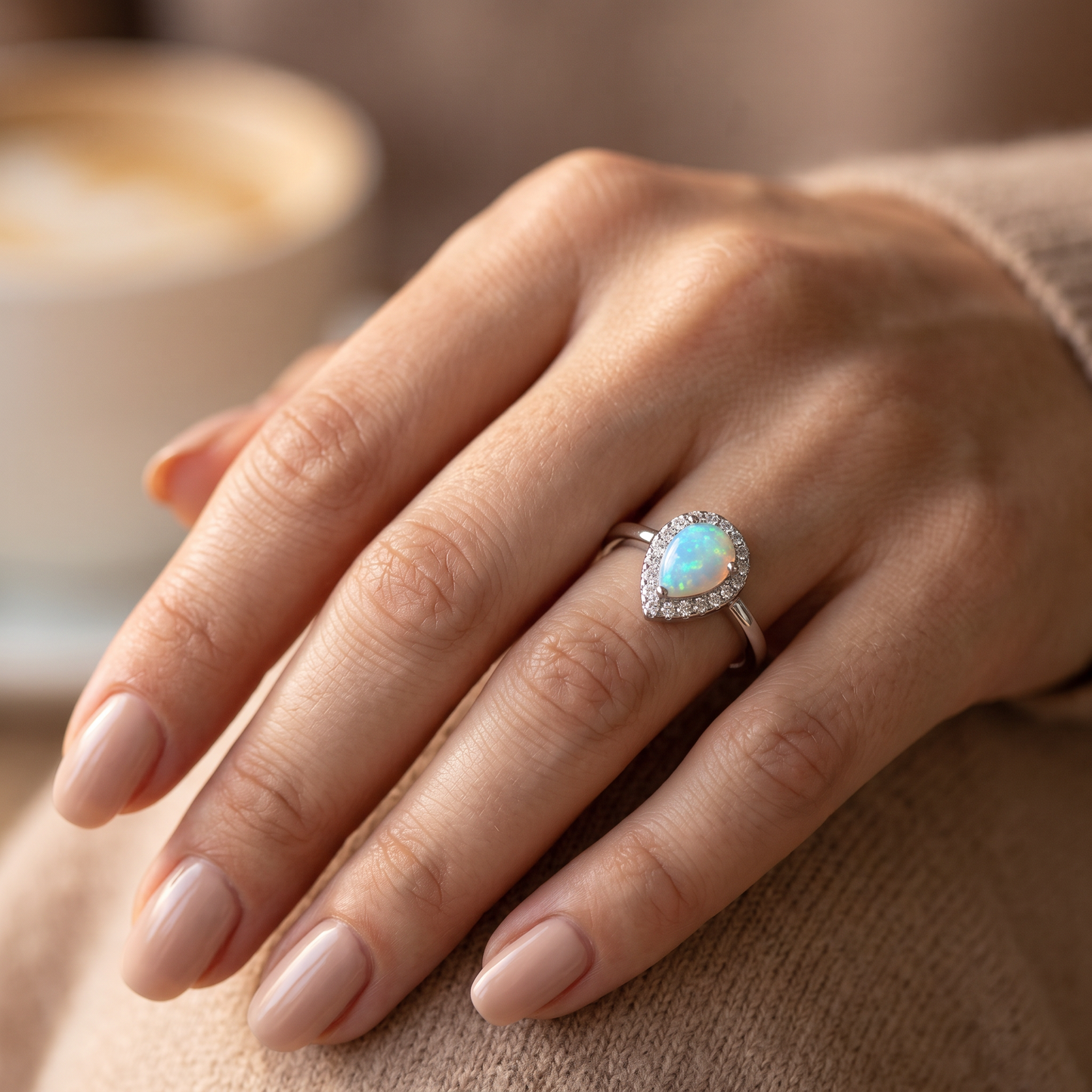 Sterling Silver White Lab Opal Tilted Pear Halo CZ Ring worn on hand