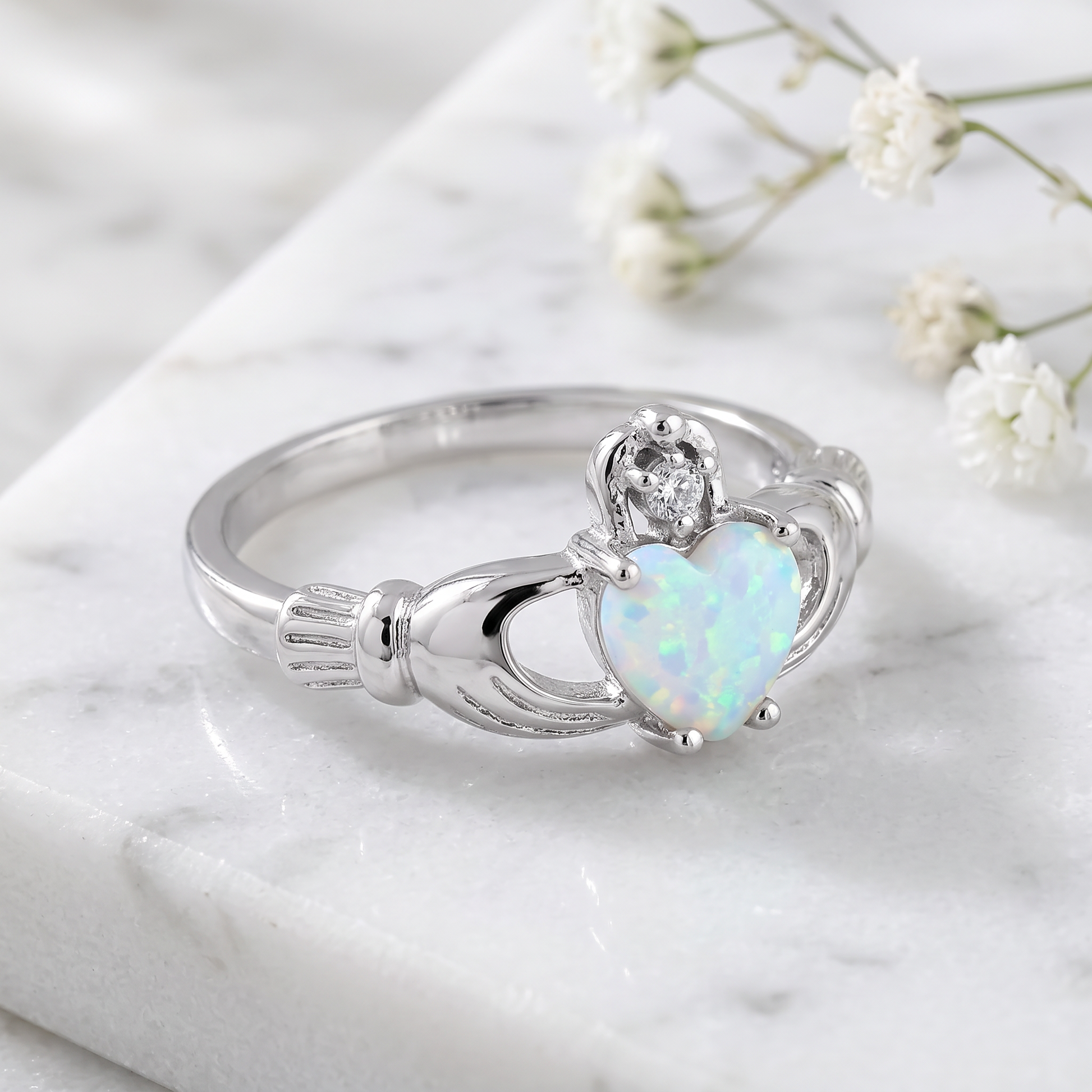 Sterling Silver Claddagh White Lab Opal CZ Ring on marble