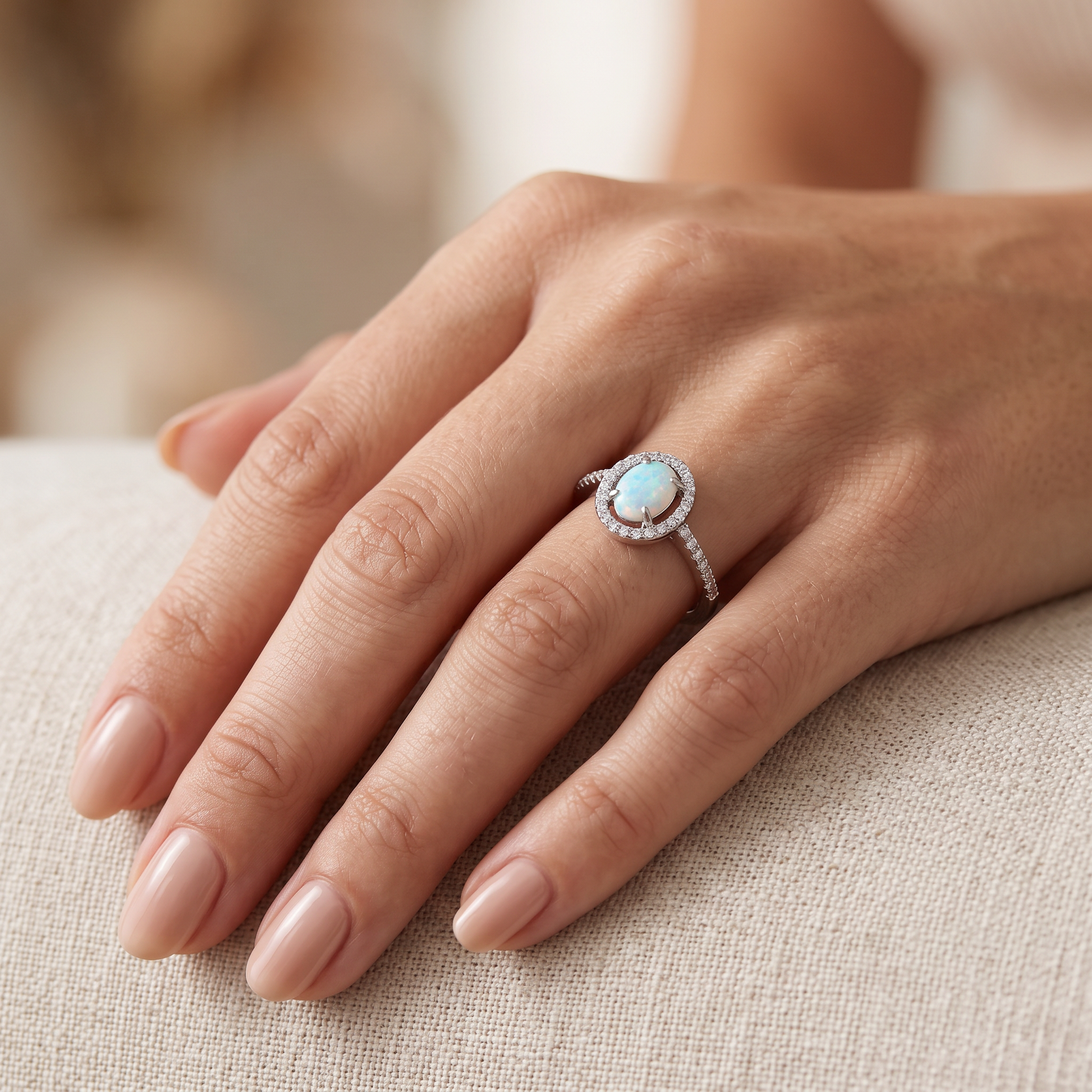 Sterling Silver White Lab Opal and Clear CZ Oval Halo Ring worn on hand