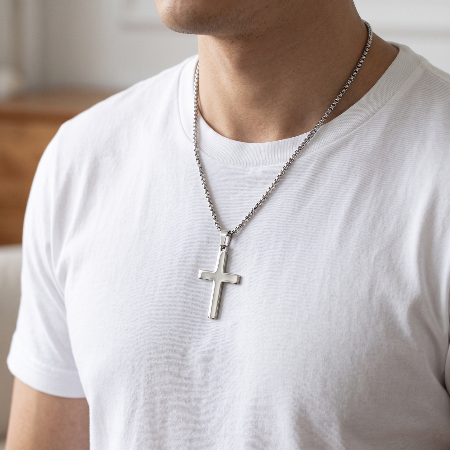 Hypoallergenic Stainless Steel Traditional Cross Necklace, 2.5mm Box Chain worn at the neckline over a white t shirt