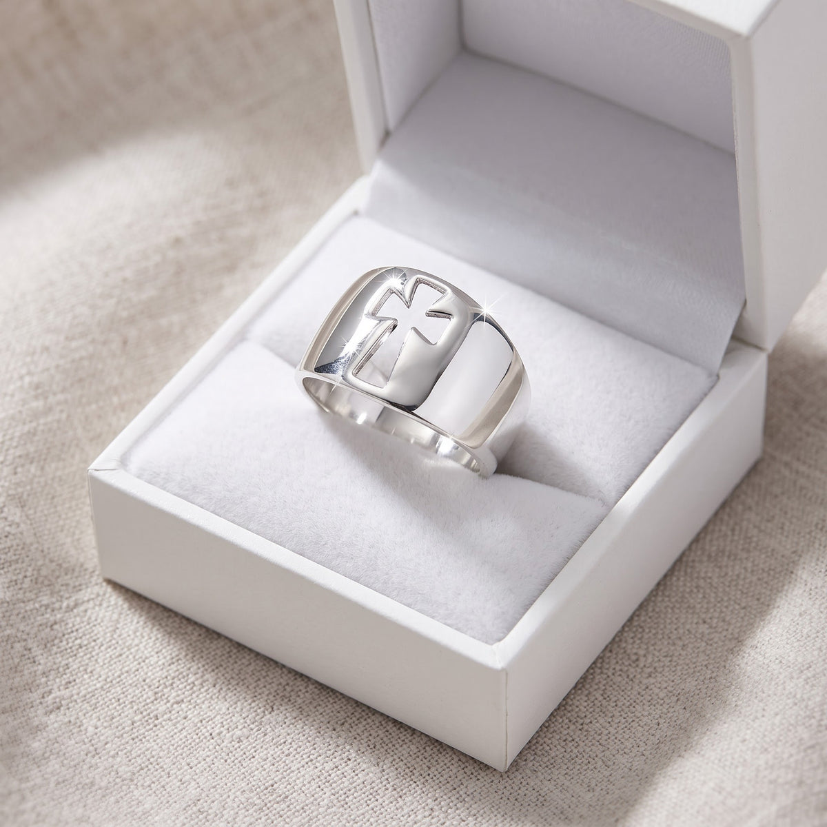 Women's Sterling Silver Cross Cut-Out Ring, 12mm Band in a white gift box, ready to give