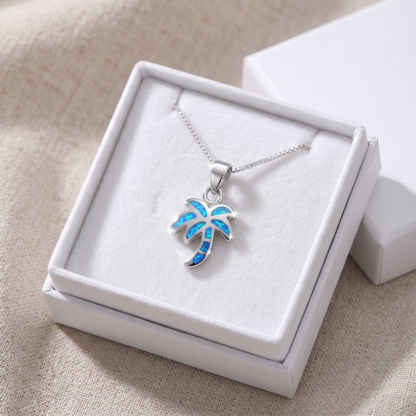 Sterling Silver Blue Created Opal Palm Tree Necklace - 24mm in a white gift box, ready to give