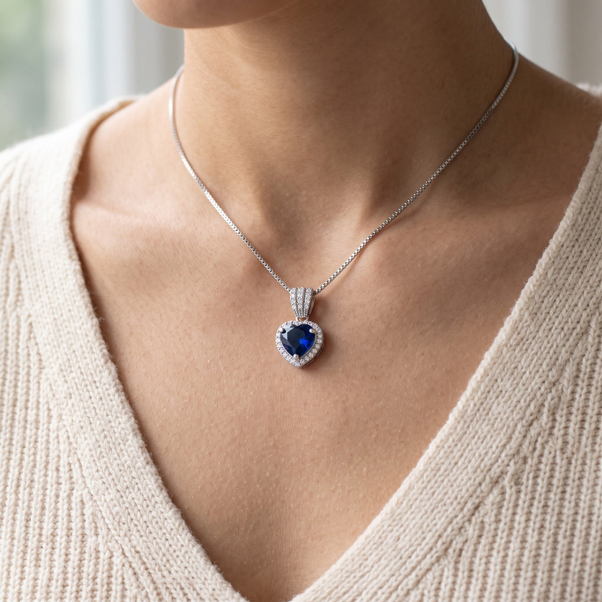 Sterling Silver Blue CZ Halo Heart Necklace worn, lifestyle photo