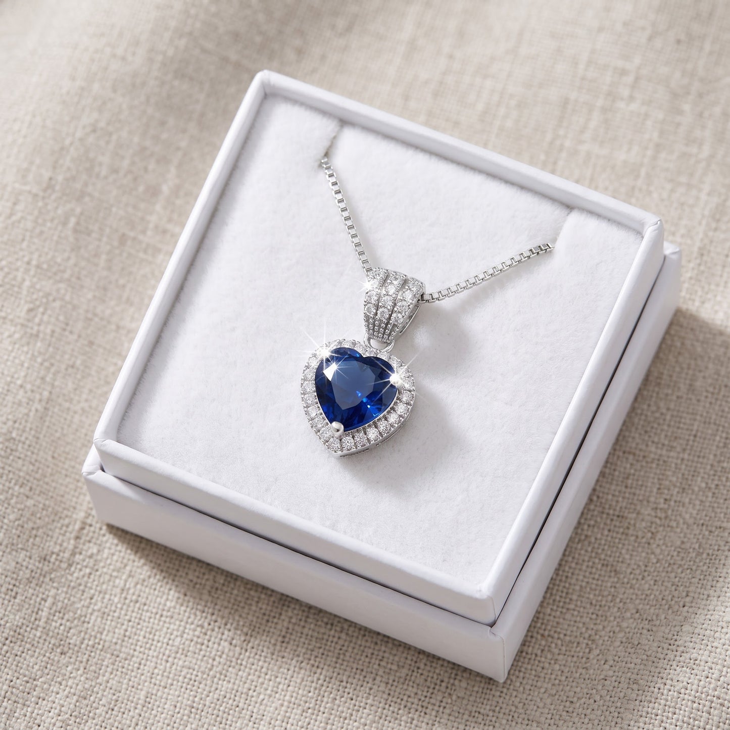Sterling Silver Blue CZ Halo Heart Necklace in a white gift box, ready to give