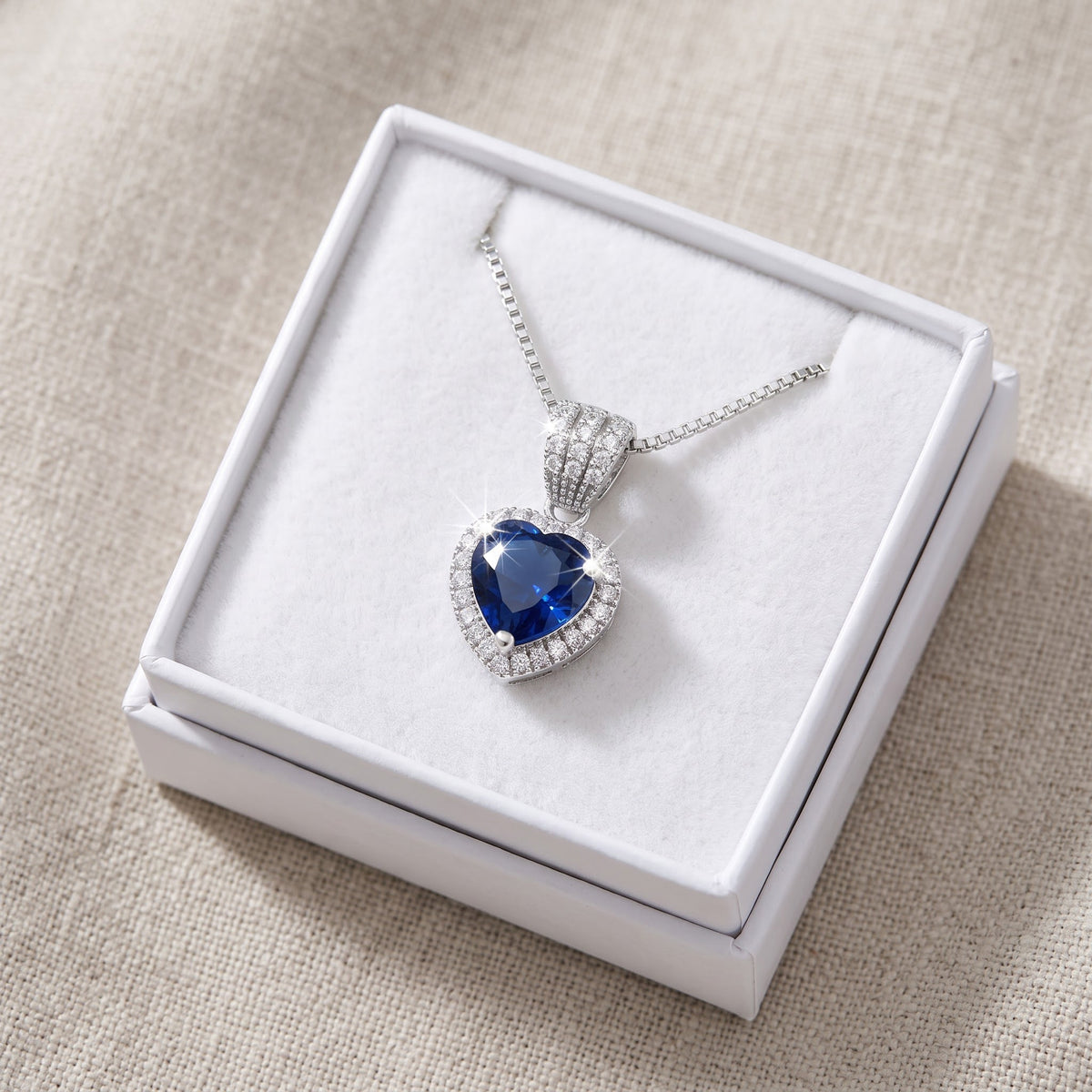 Sterling Silver Blue CZ Halo Heart Necklace in a white gift box, ready to give