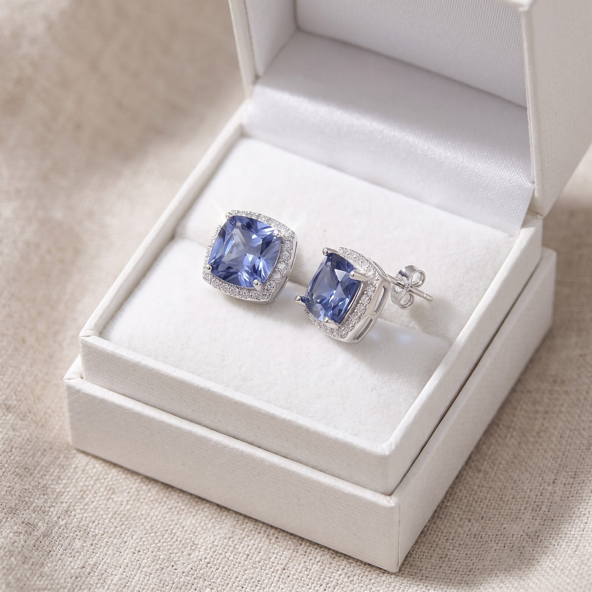 Sterling Silver Blue CZ Halo Stud Earrings, 11mm in a white gift box, ready to give