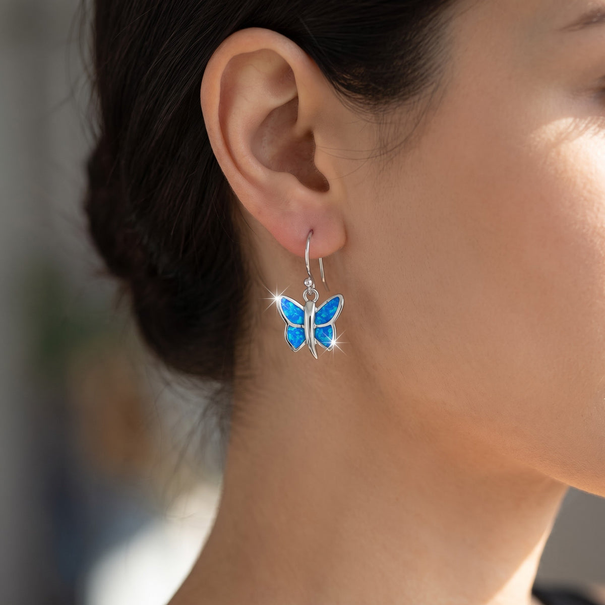 Sterling Silver Girls Blue Created Opal Butterfly Fish hook Earrings worn, lifestyle photo