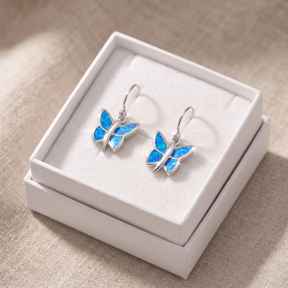 Sterling Silver Girls Blue Created Opal Butterfly Fish hook Earrings in a white gift box, ready to give
