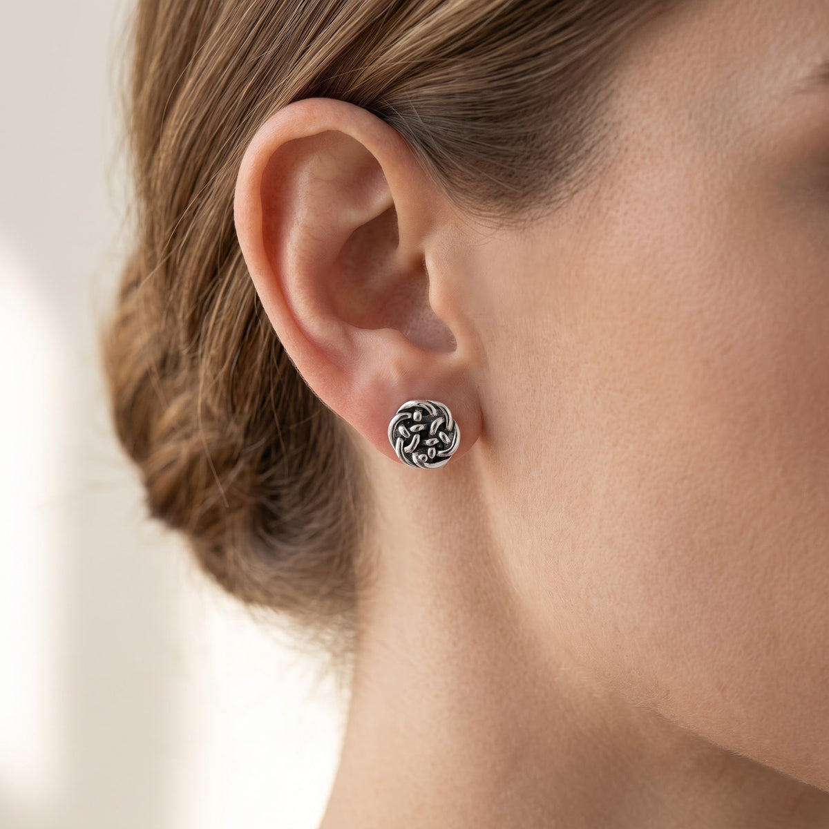 Rhodium-Plated Sterling Silver Women's Small Antrim Knot Celtic Stud Earrings worn, lifestyle photo